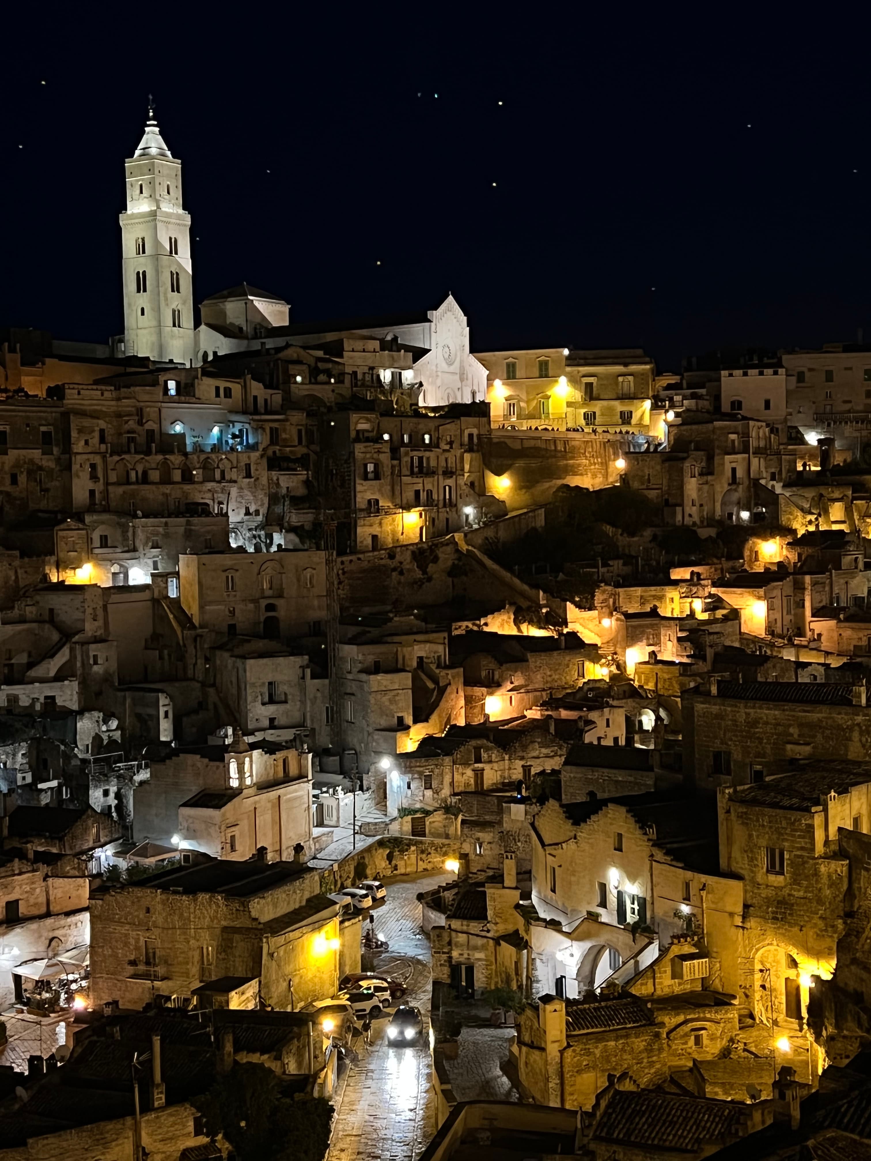 Aerial view of a town at nighttime with buildings and streets lit up