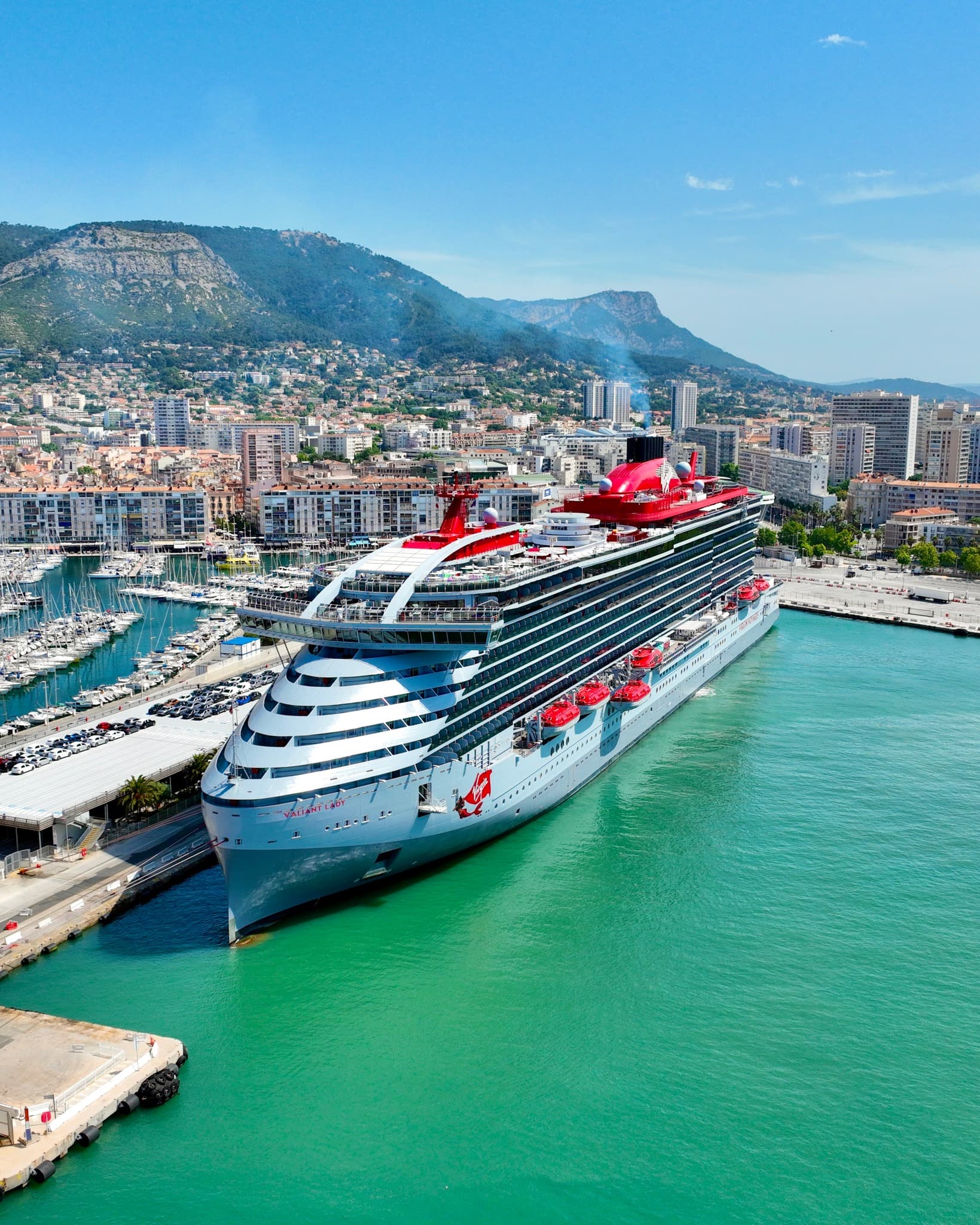 Aerial view of a cruise ship docked in the water near a port