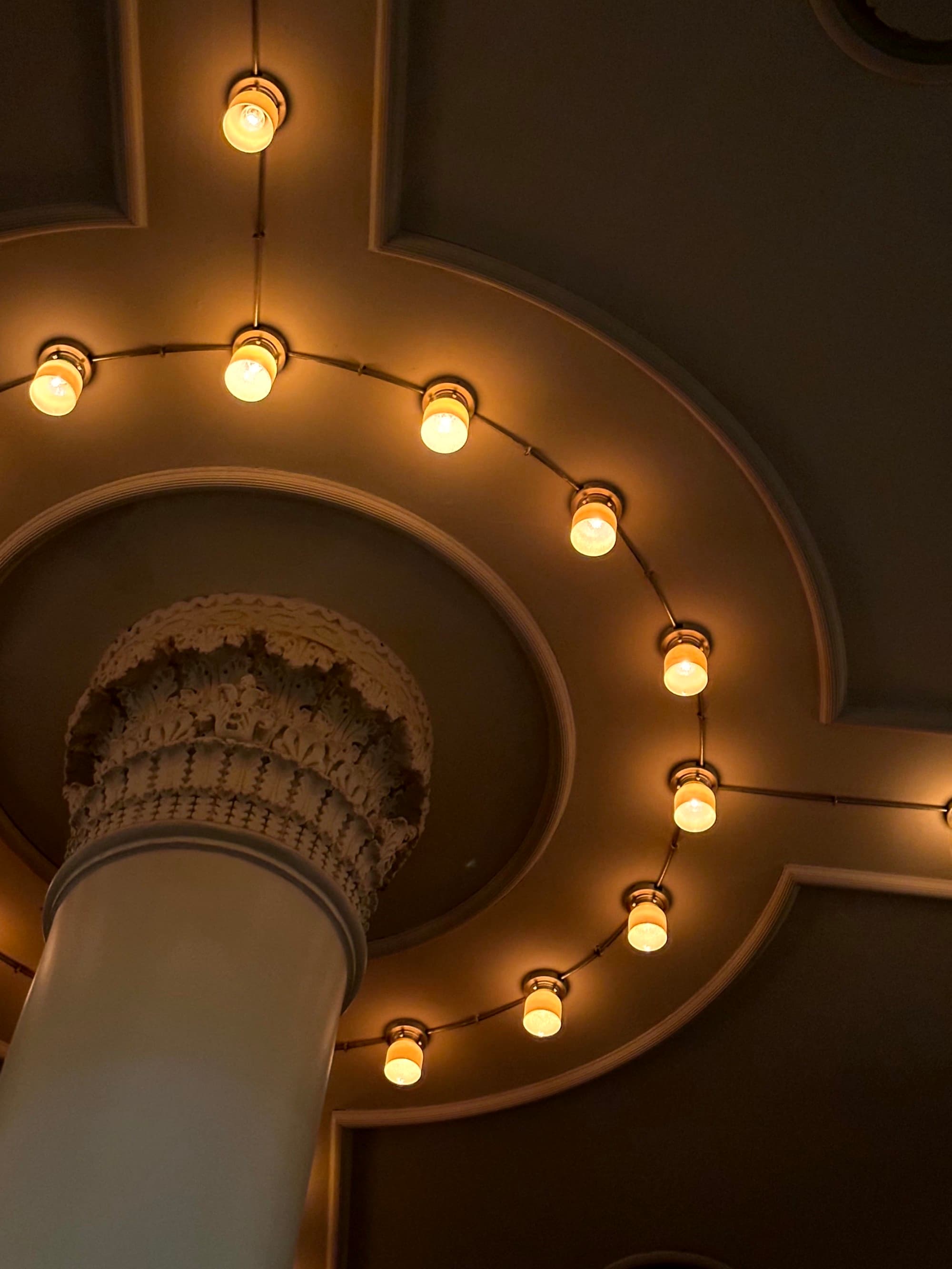 A captivating display of circular ceiling lights offers an artistic architectural perspective.
