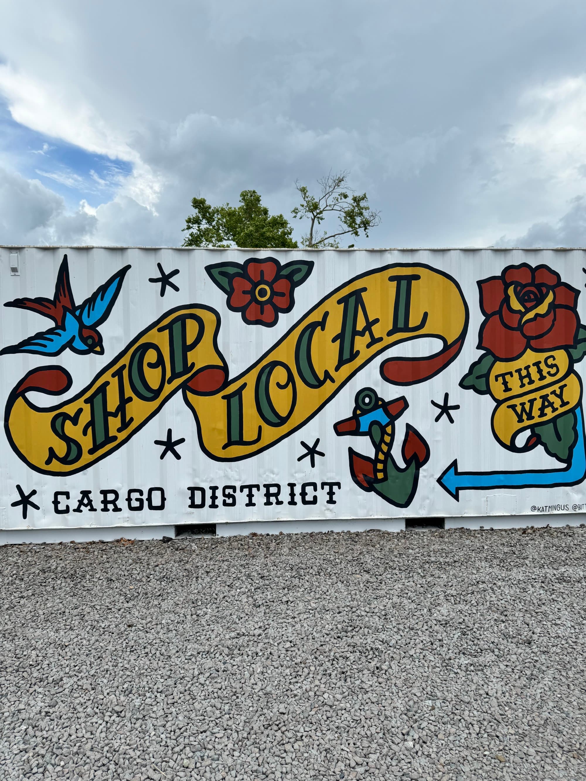 Wall art with the text 'Shop local' painted.