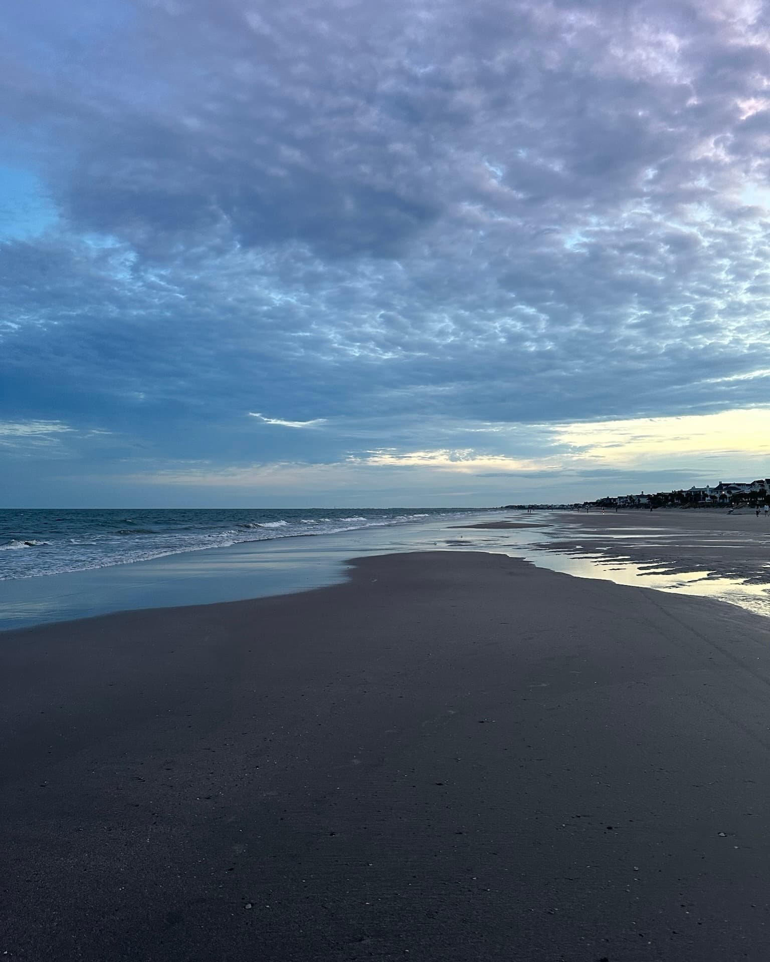 A vast beach during a cloudy evening