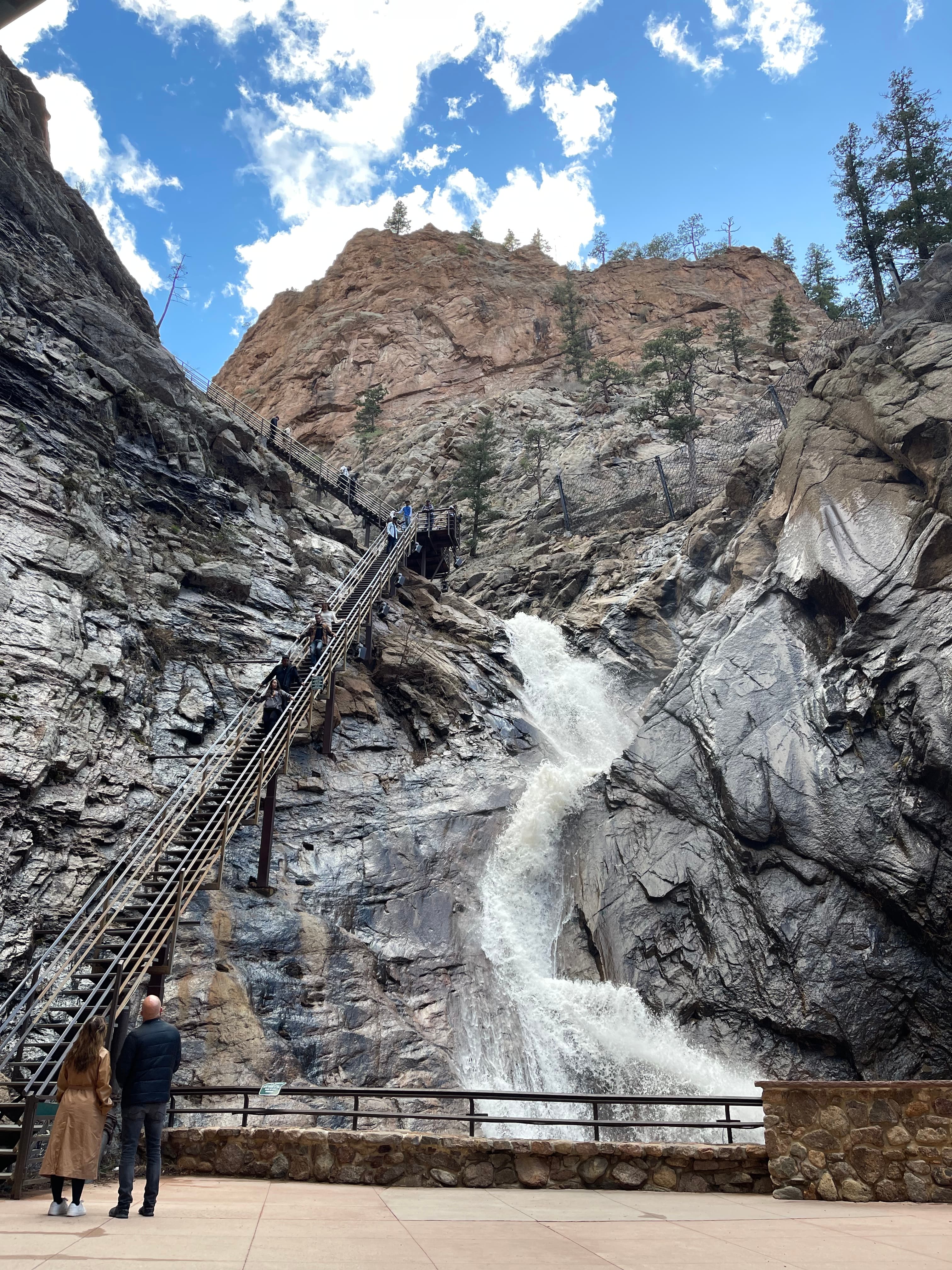 A waterfall down a mountain during the daytime