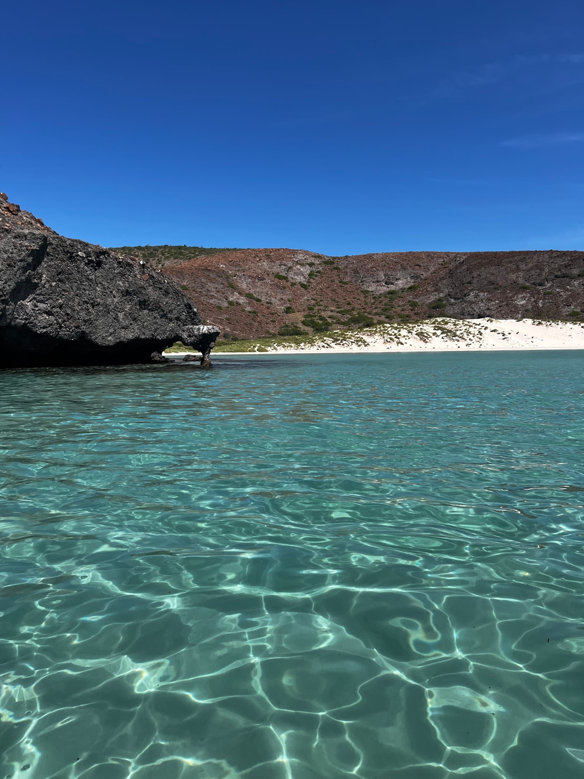 A view of a beach from the water during the daytime
