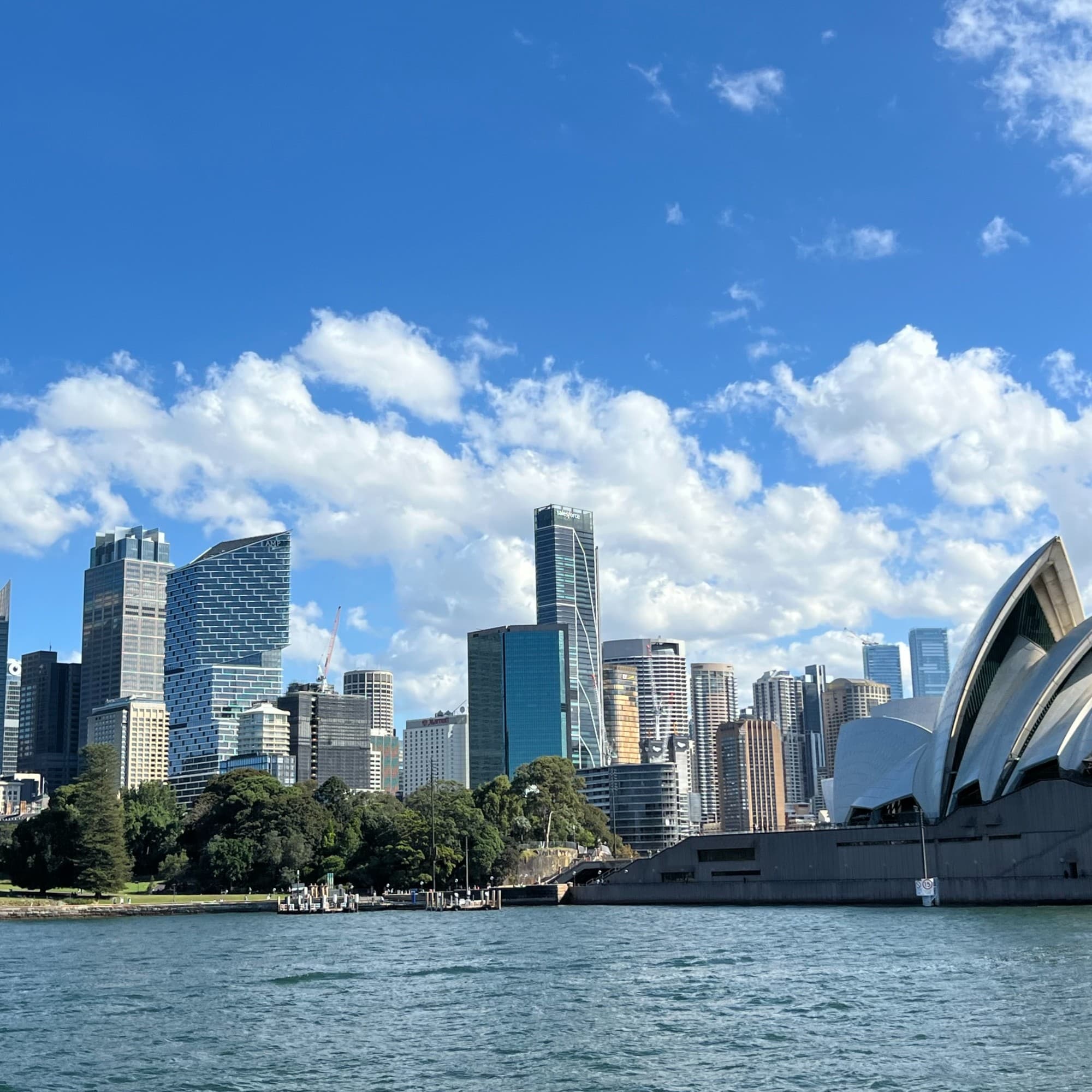 The Sydney skyline, Opera House and Harbour on a sunny day.