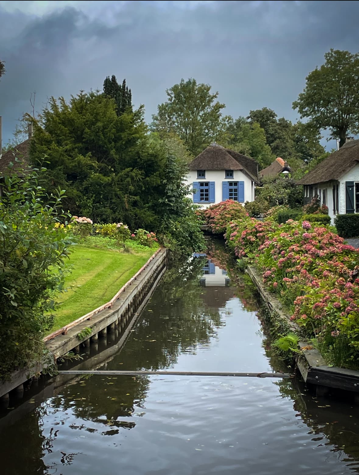 Canal flowing in front of houses.