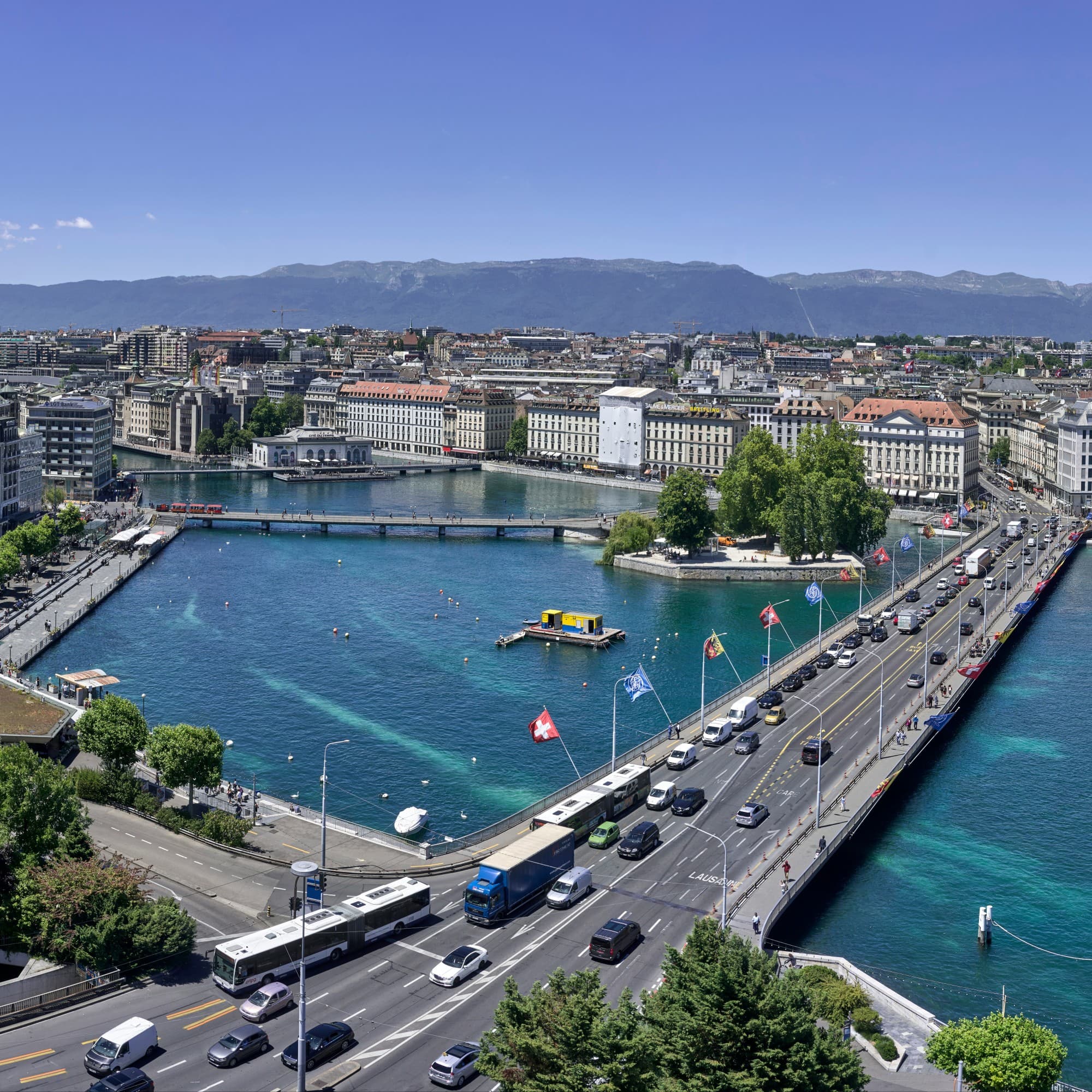 Aerial view of city with buildings, bridge and waterbody.