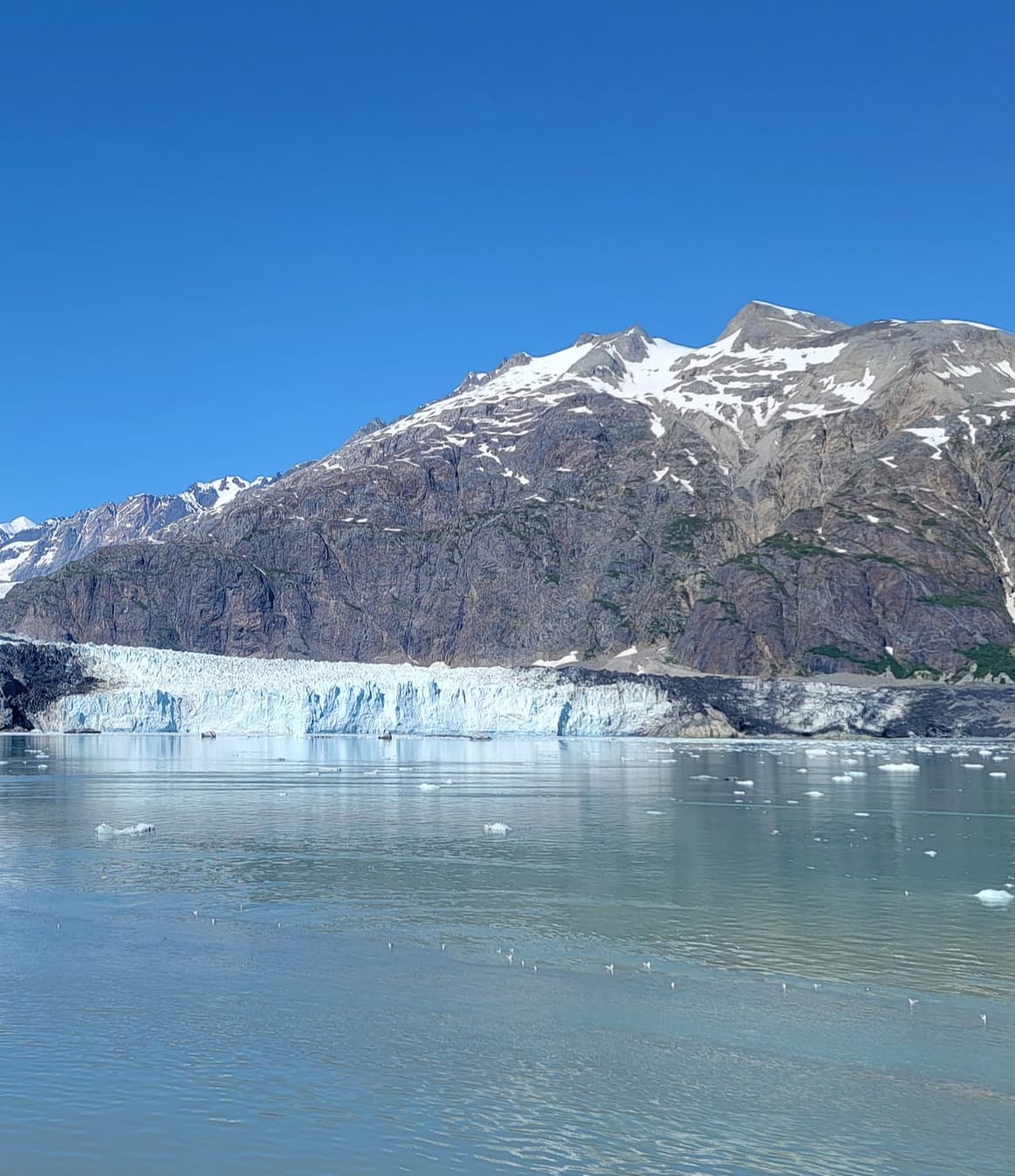 A large glacier with mountains in the background.