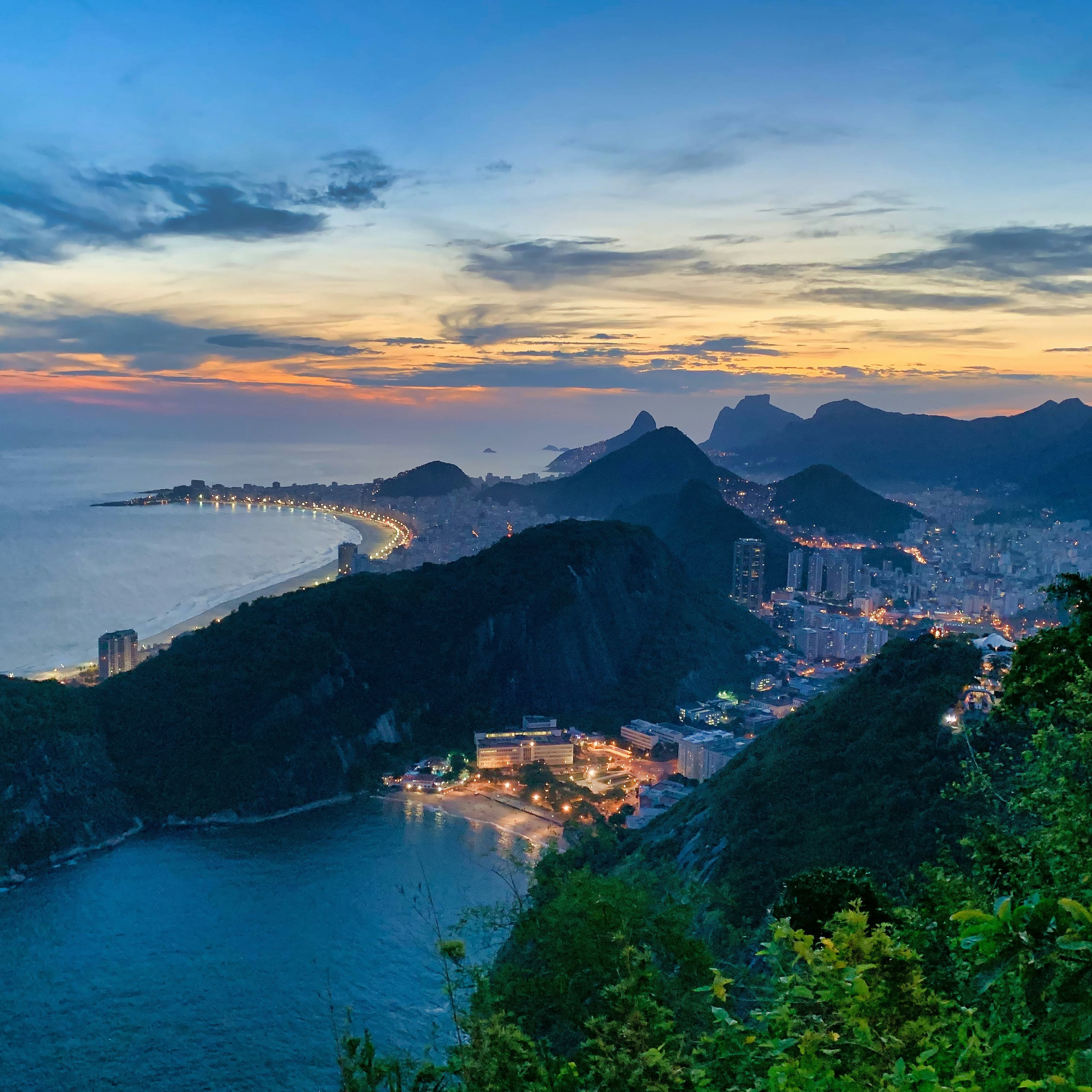 Aerial view of ocean, mountain and coastal city.