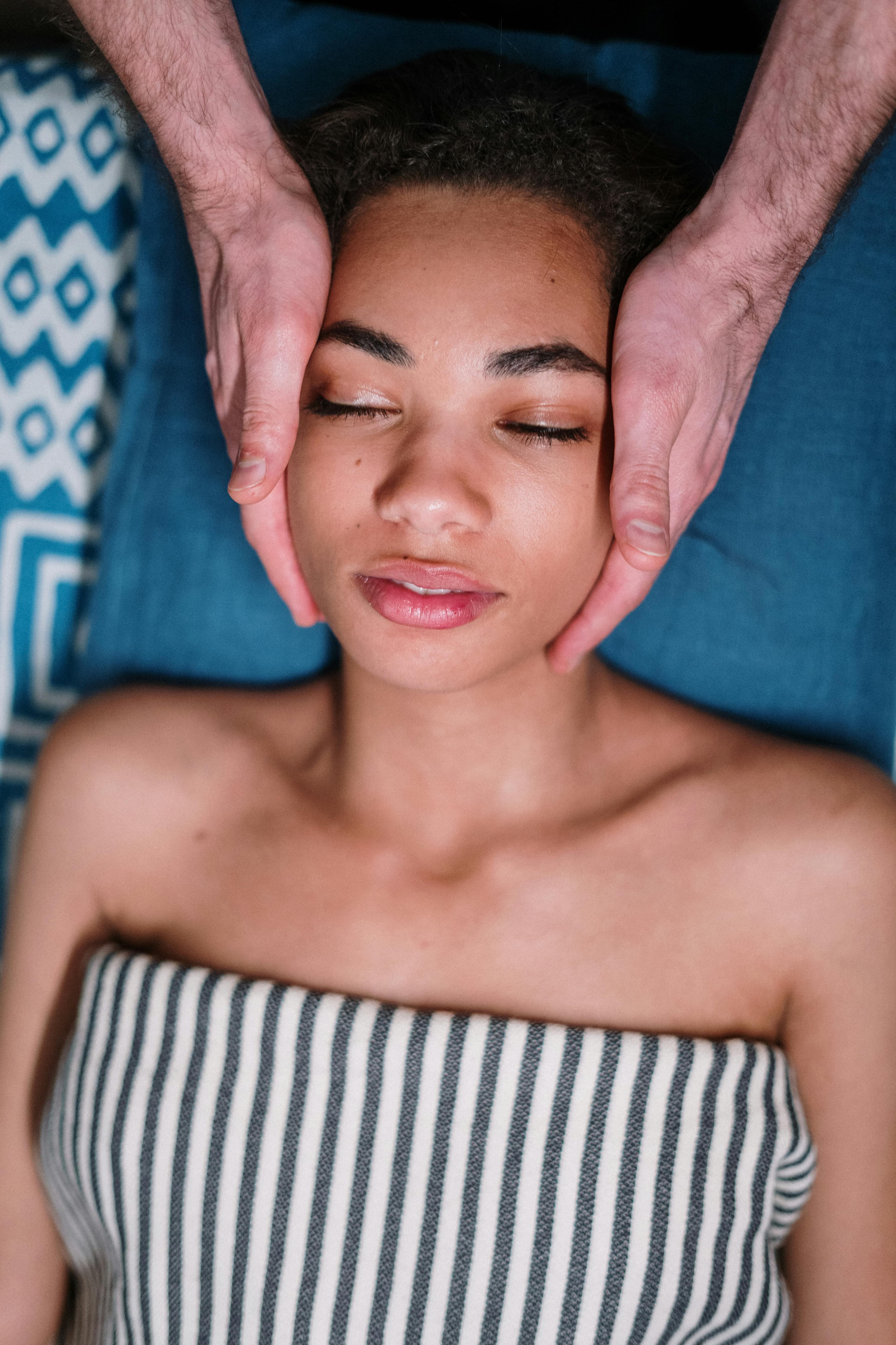 A woman getting a massage with her eyes closed.