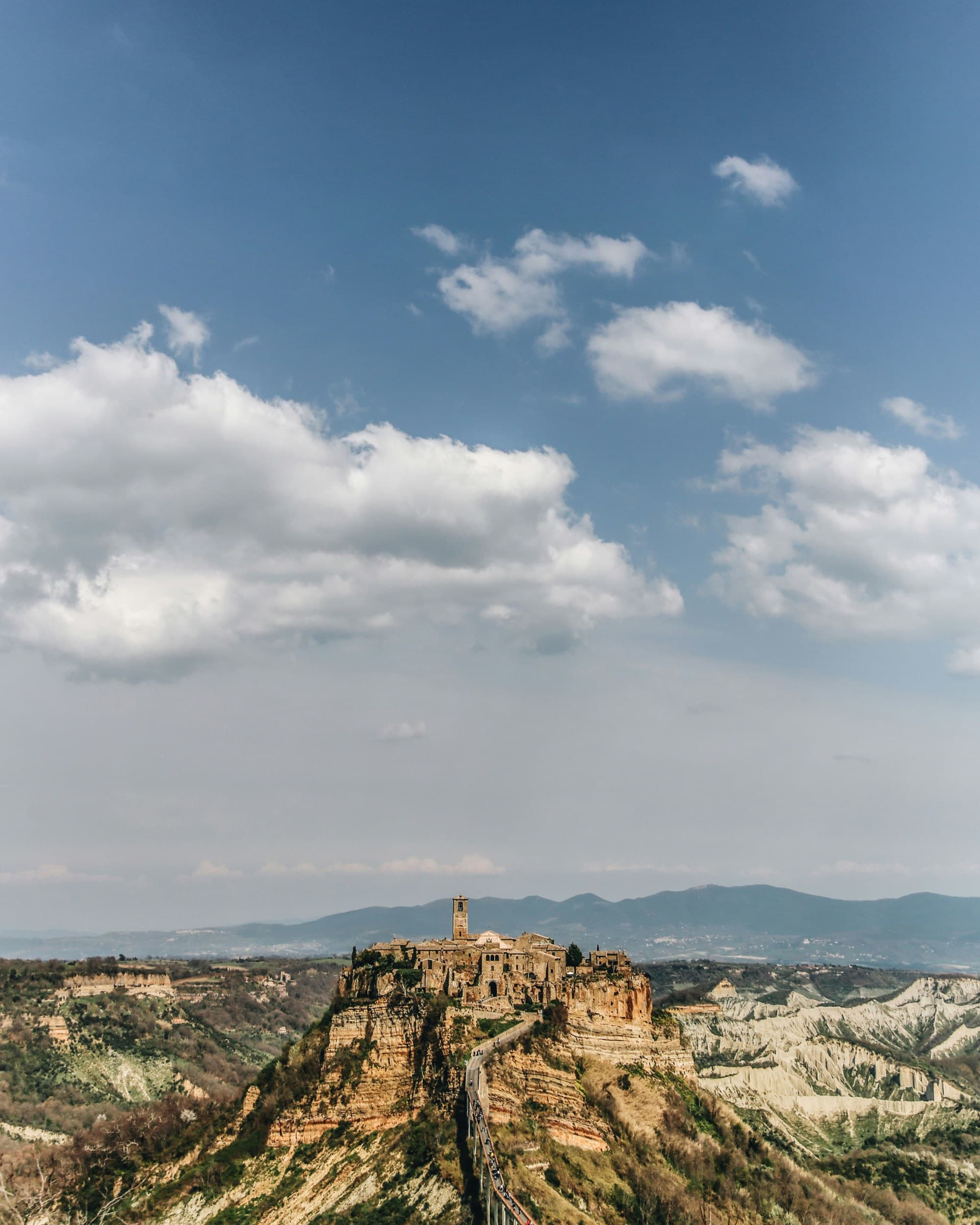 Brown rock formation under blue sky during daytime.