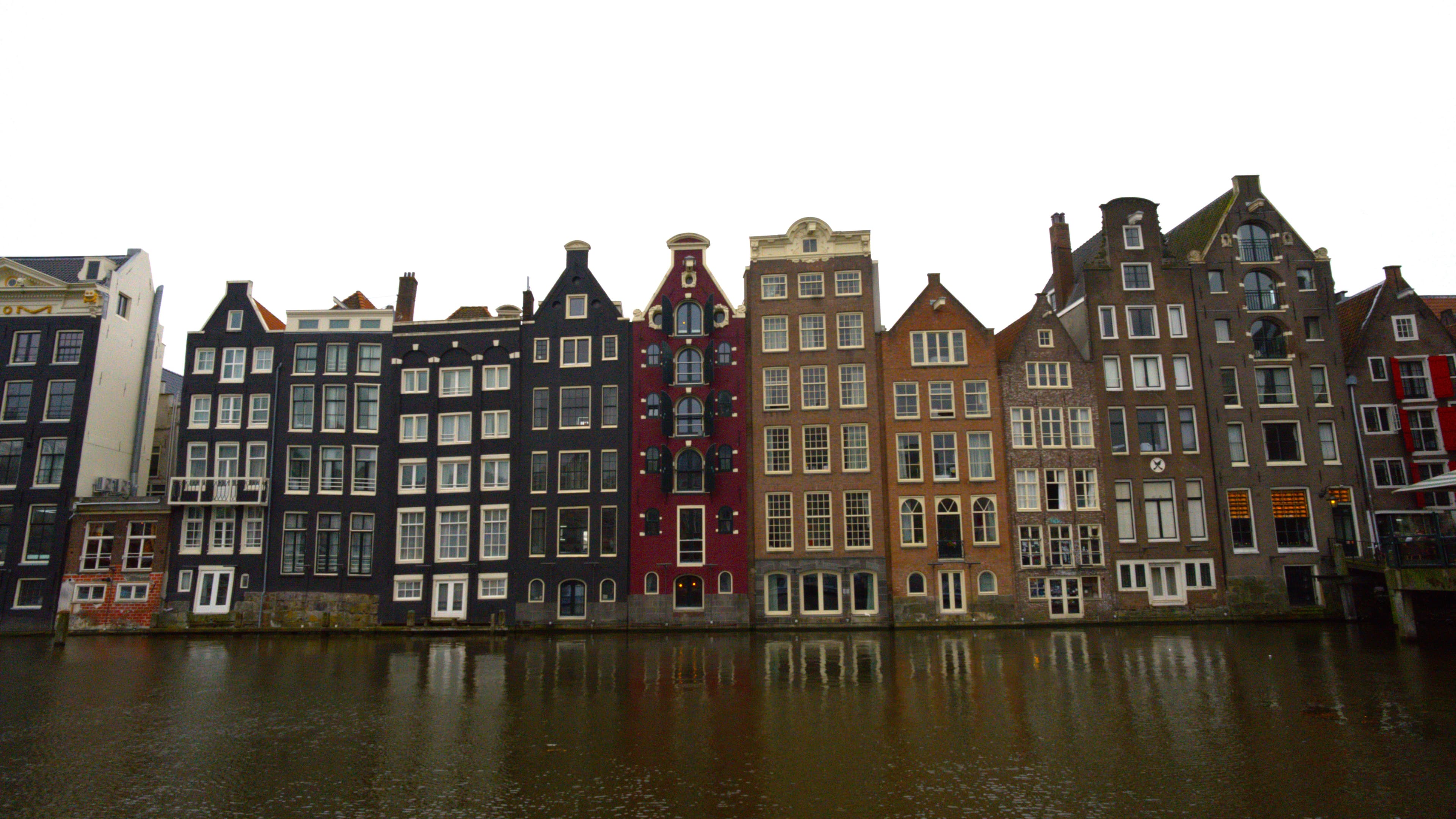 A rowe of tall buildings on a canal