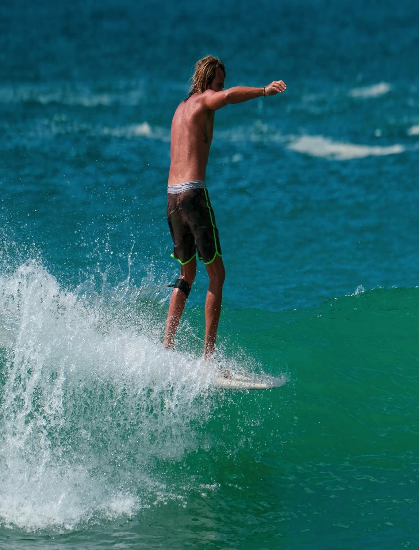 A picture of a man surfing on sea waves during daytime.