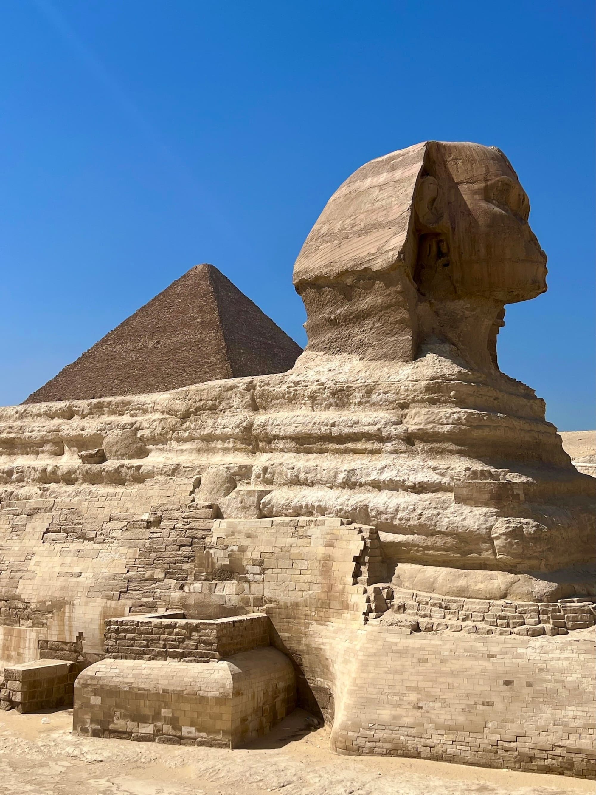 A view of the Great Sphinx of Giza in Egypt with the blue sky in the background.