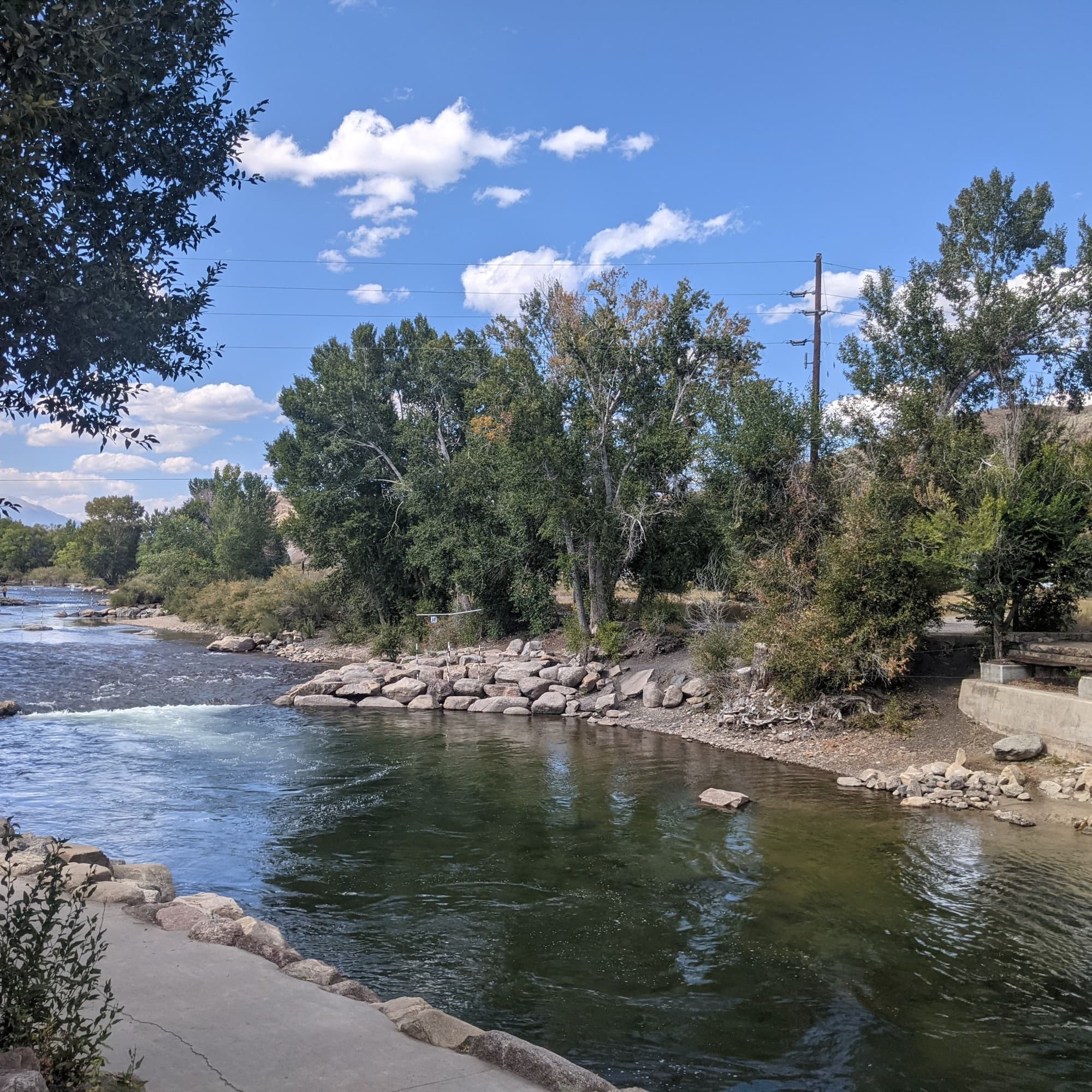 A river flowing surrounded by rocks and trees.
