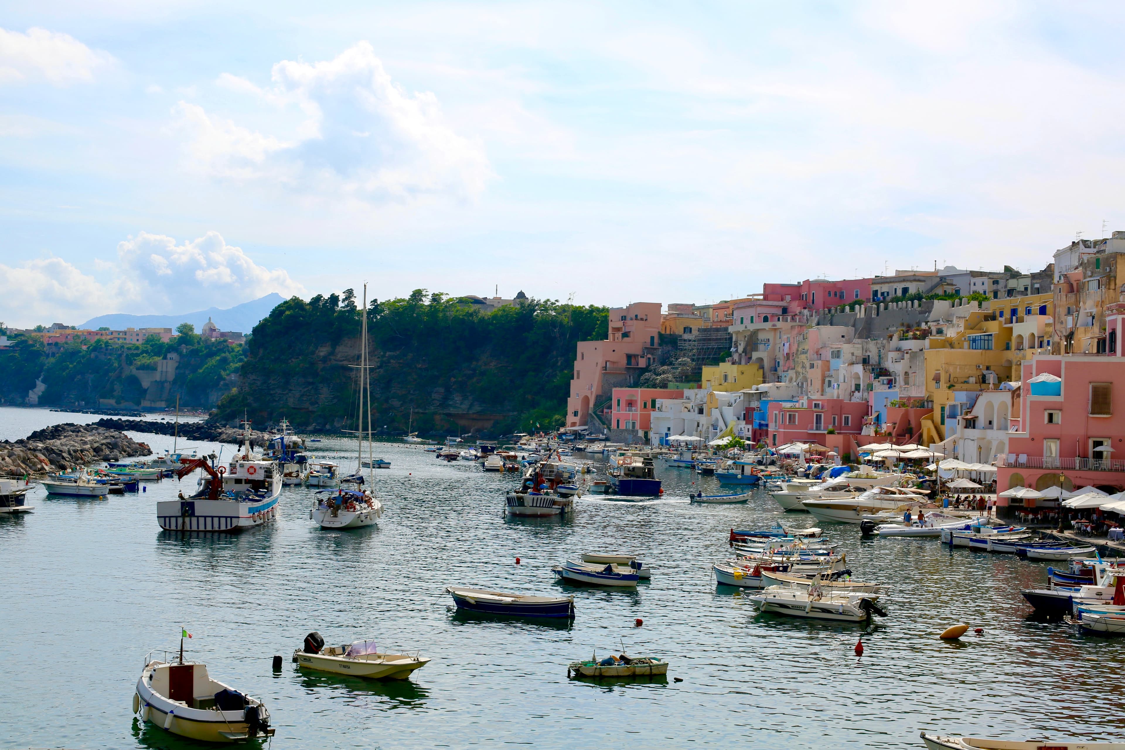 Procida Marina Chiaolella – boats in a harbor with colorful buildings along the coast