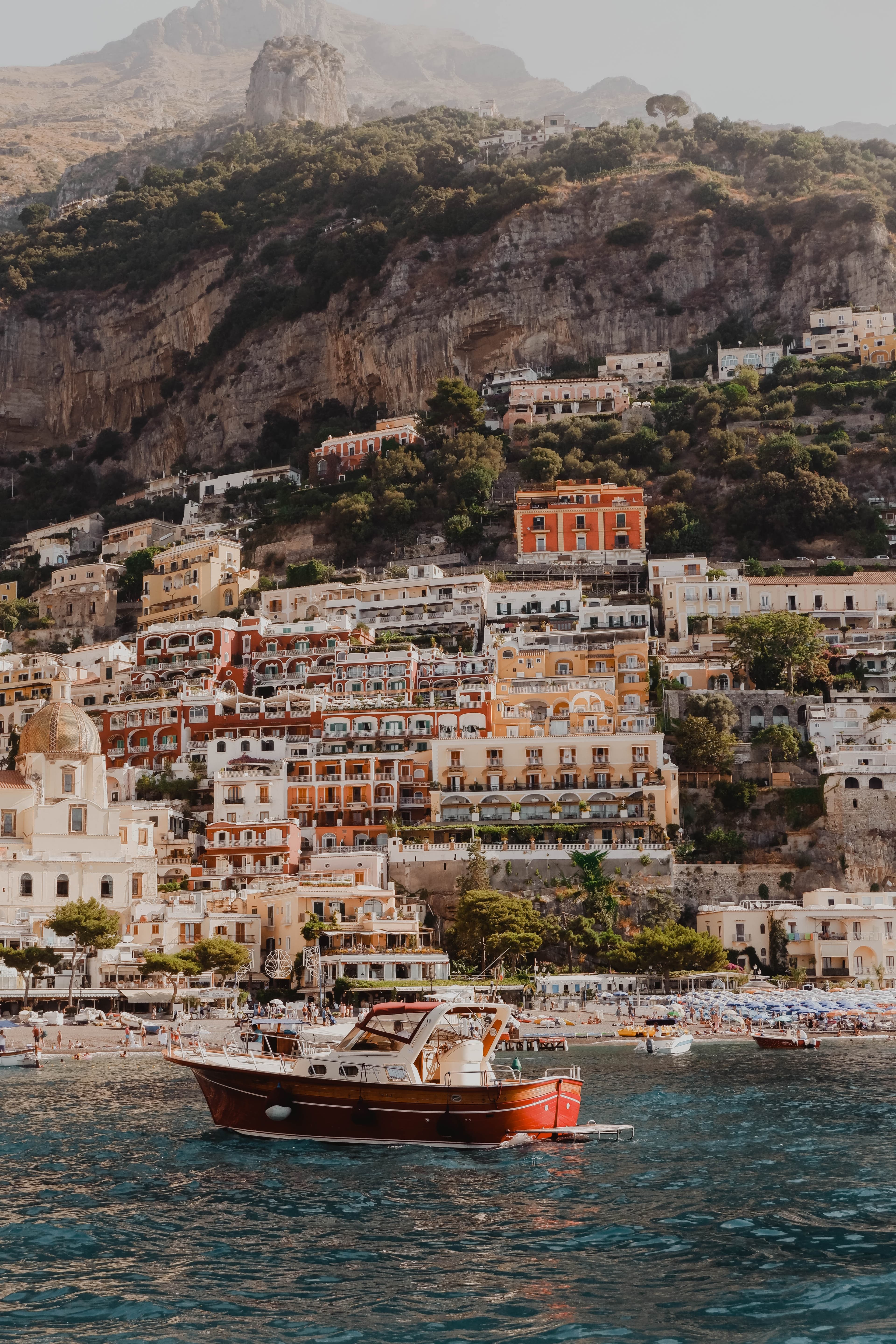 Boat in the water with buildings in the background in Positano, Italy