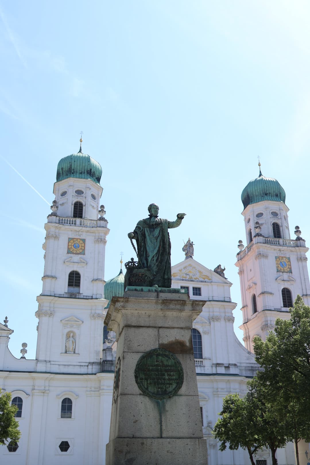 A statue of a man in front of a white building during the daytime