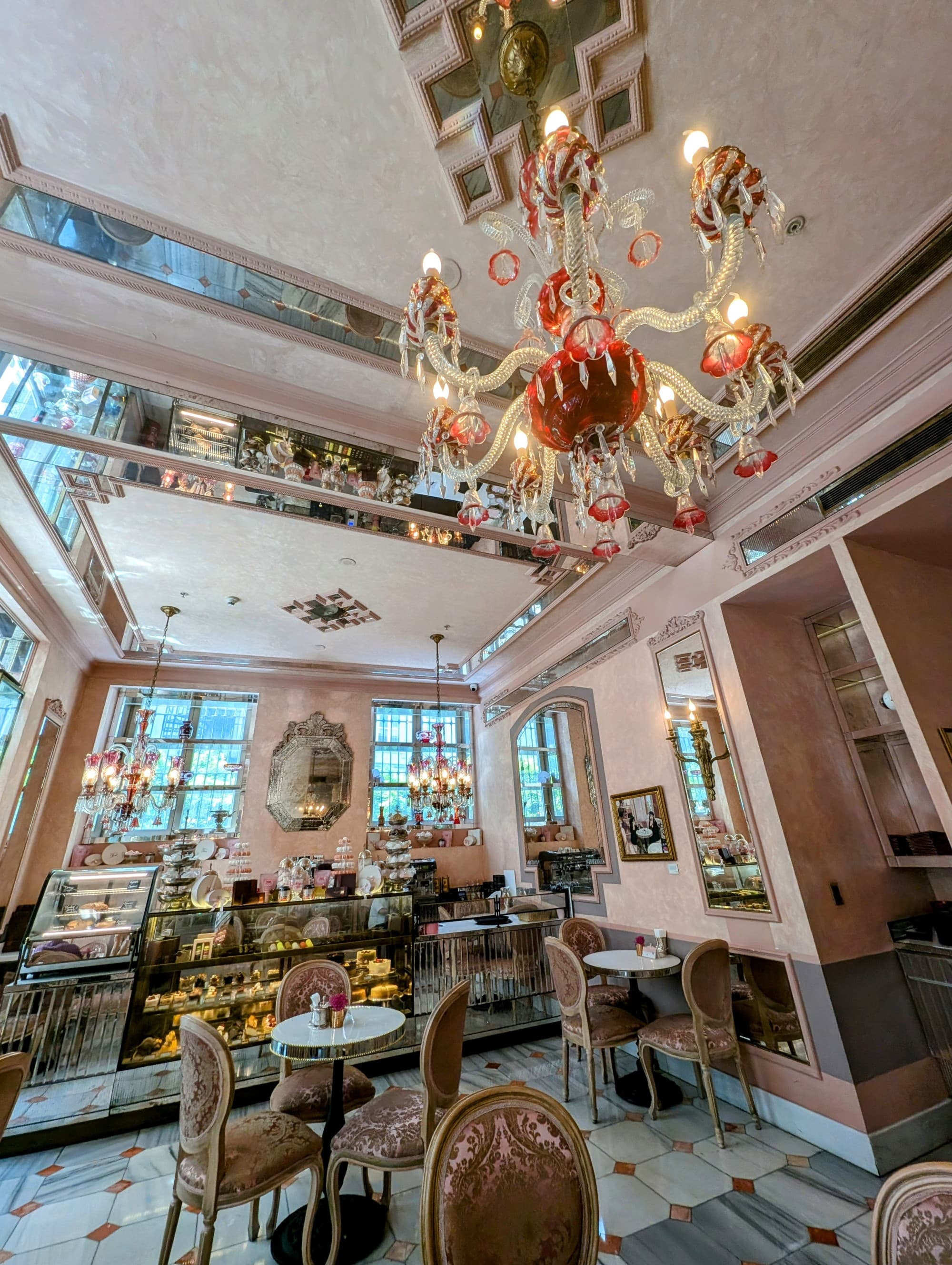 A hotel lobby with an ornate glass chandelier.
