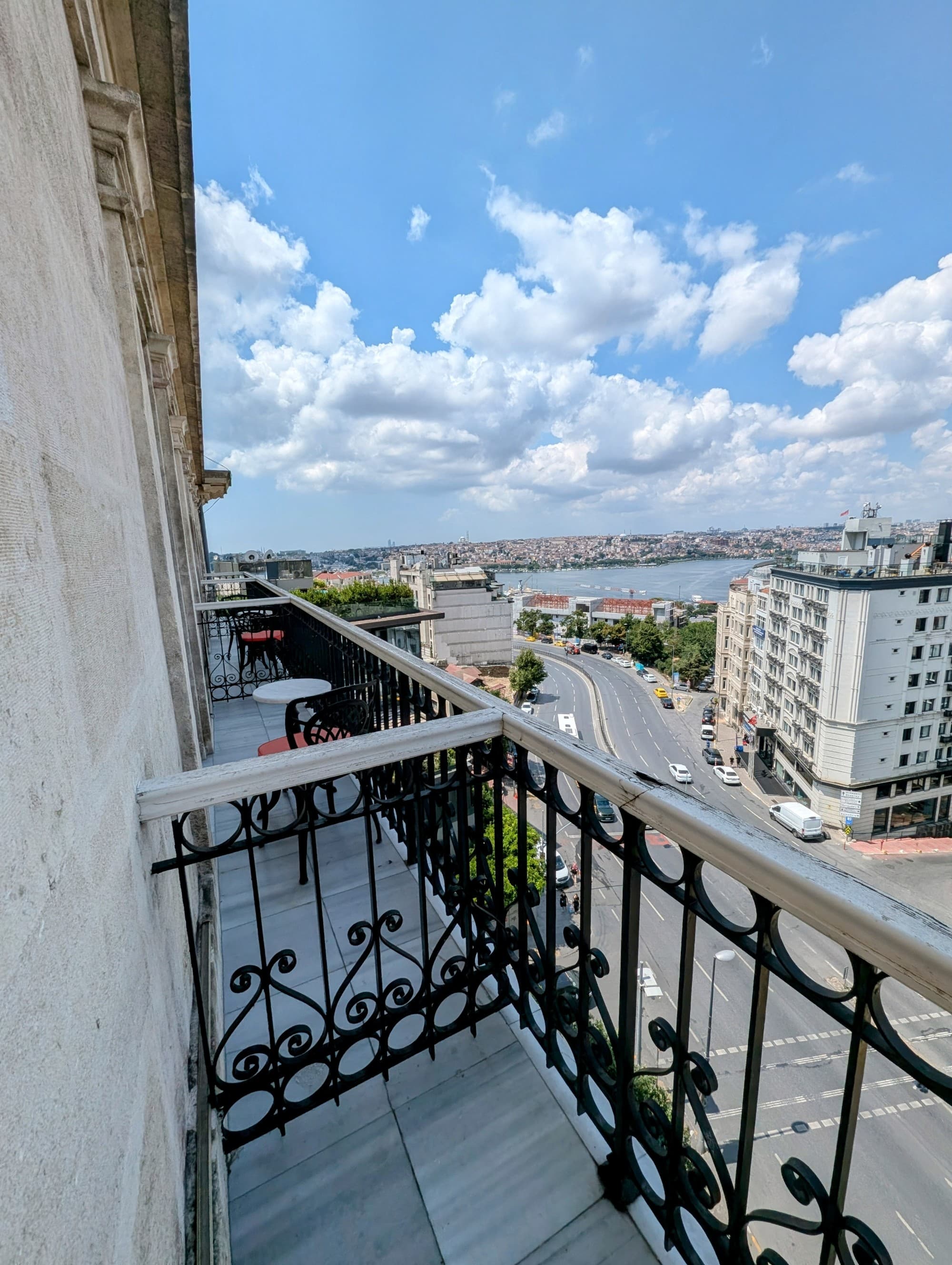Balcony view of a city with a cloudy sky.