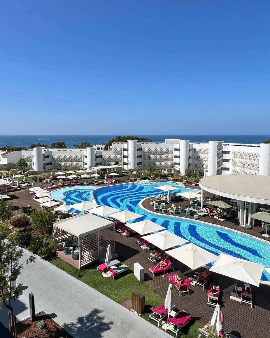 Aerial view of the resort grounds with a large swimming pool in the center