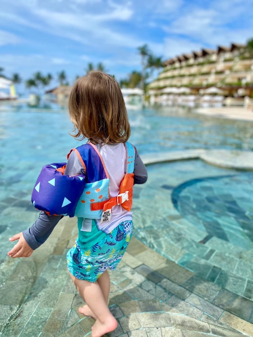 A child in an outside pool area