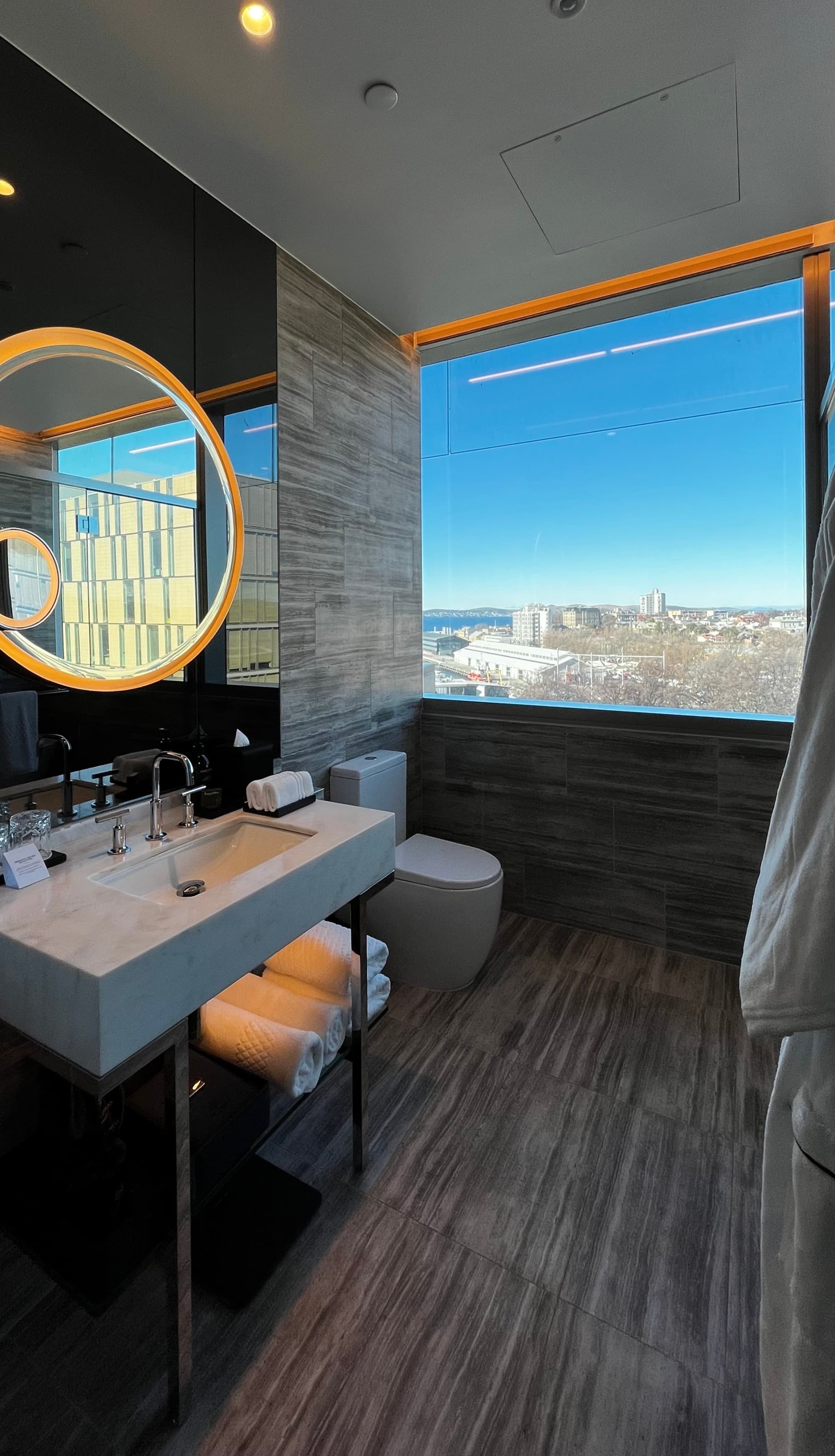 Bathroom at The Tasman, Hobart overlooking the water on a sunny day.