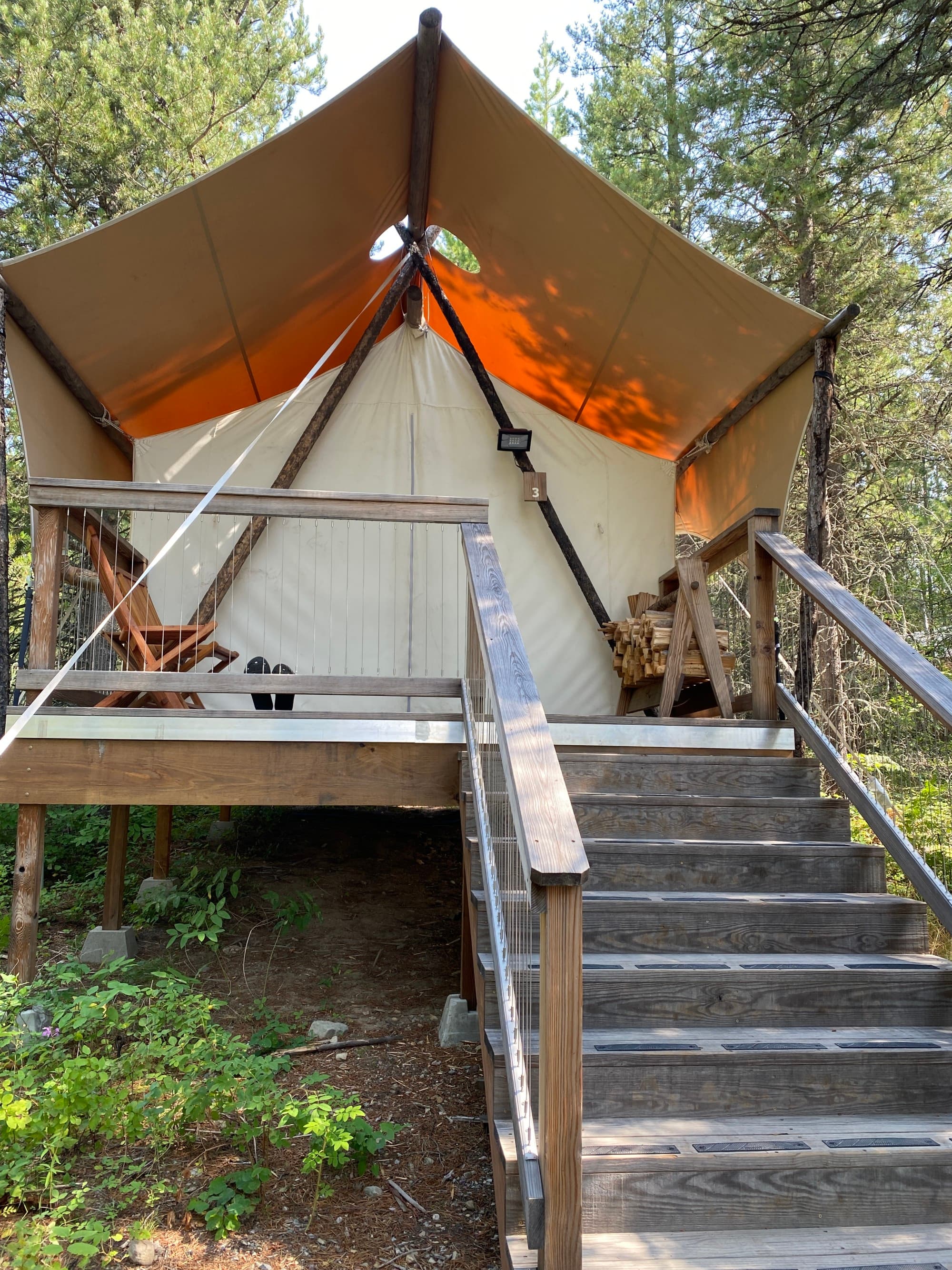 A set of wooden stairs leading to an outdoor tent during the daytime