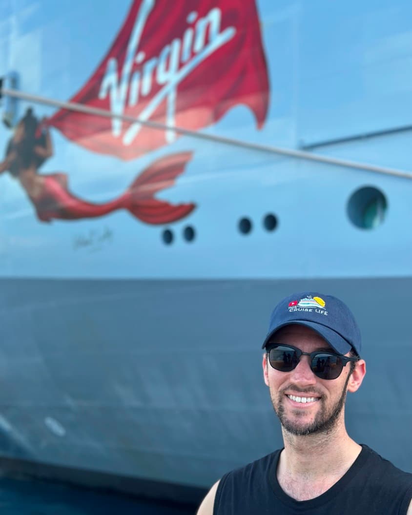 A picture of the advisor standing in front of the cruise ship.