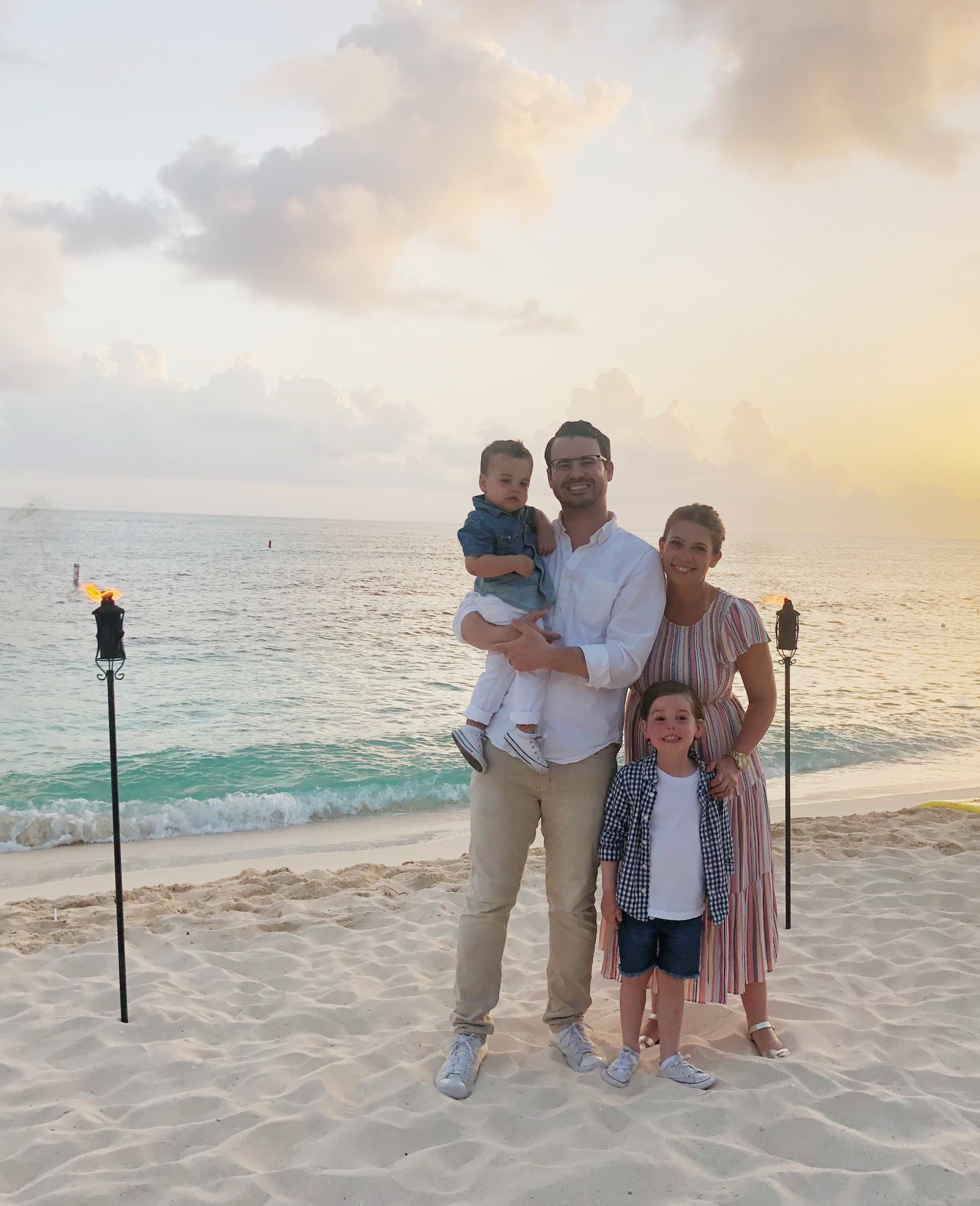 Family posing on the beach.