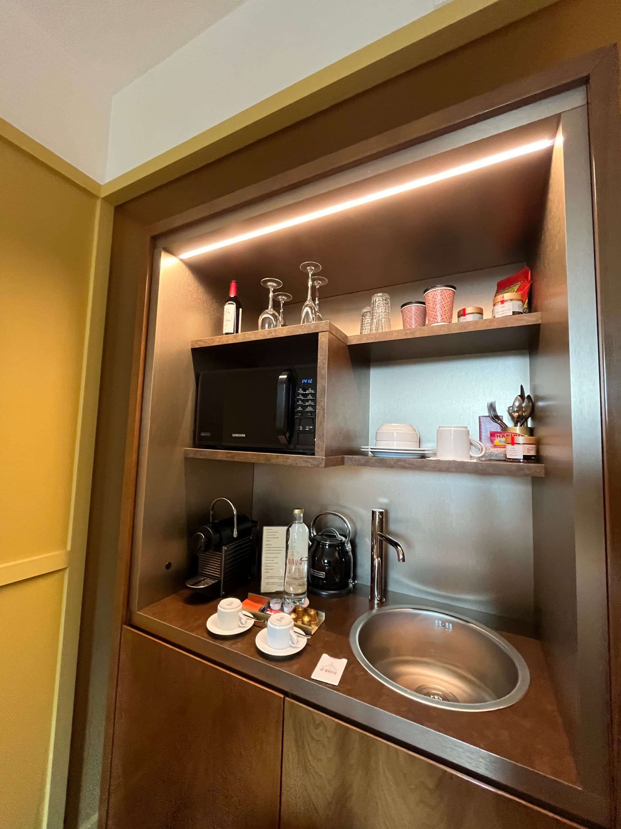 Kitchenette with brown countertops.
