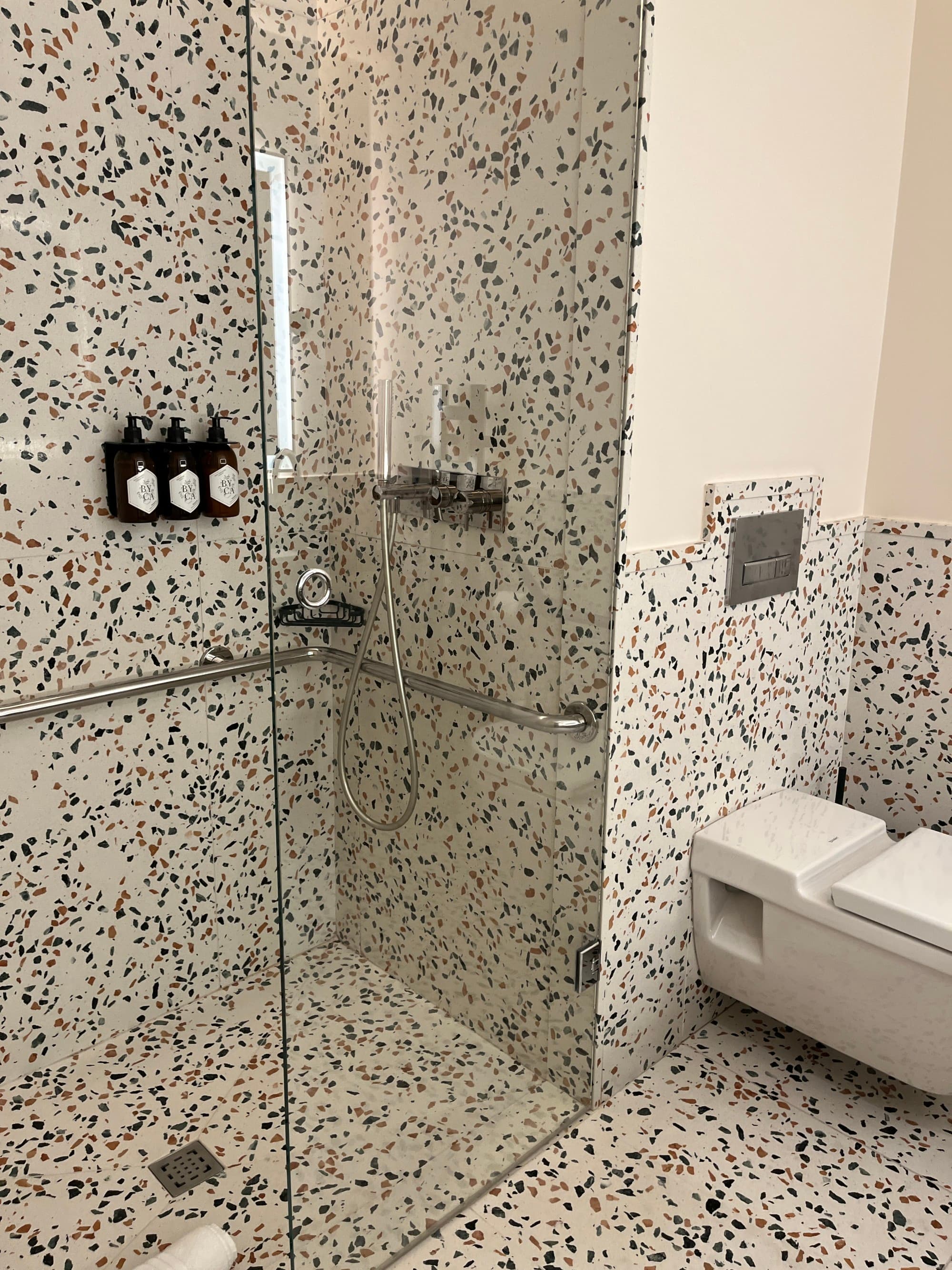 Shower with a black-on-white splatter pattern.