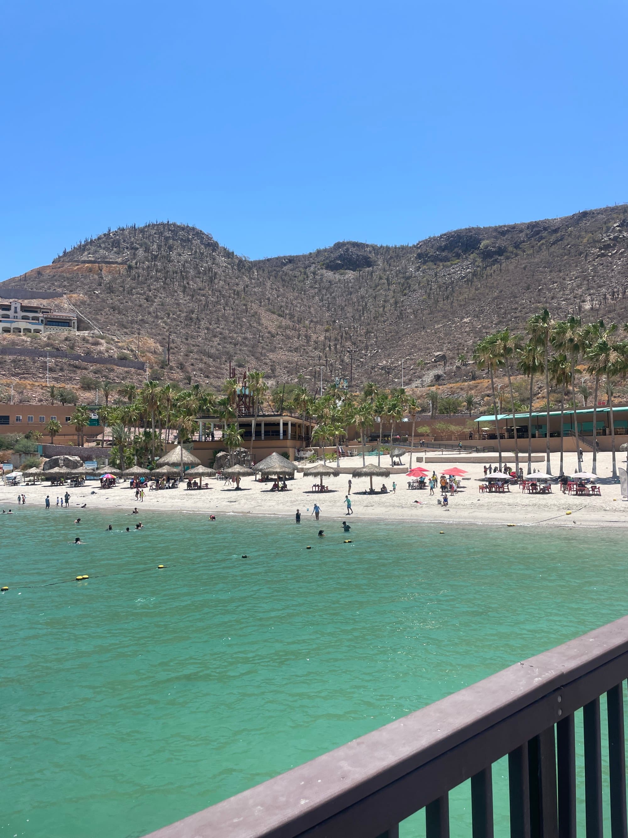 Sea and seaside view with blue water and rolling hills behind.