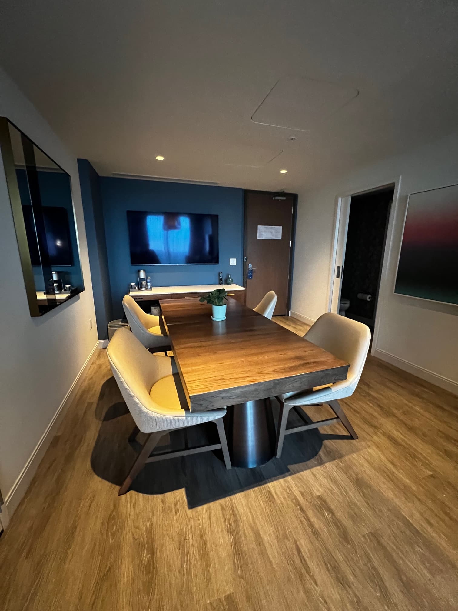 Dining area with wooden floors and wooden table.
