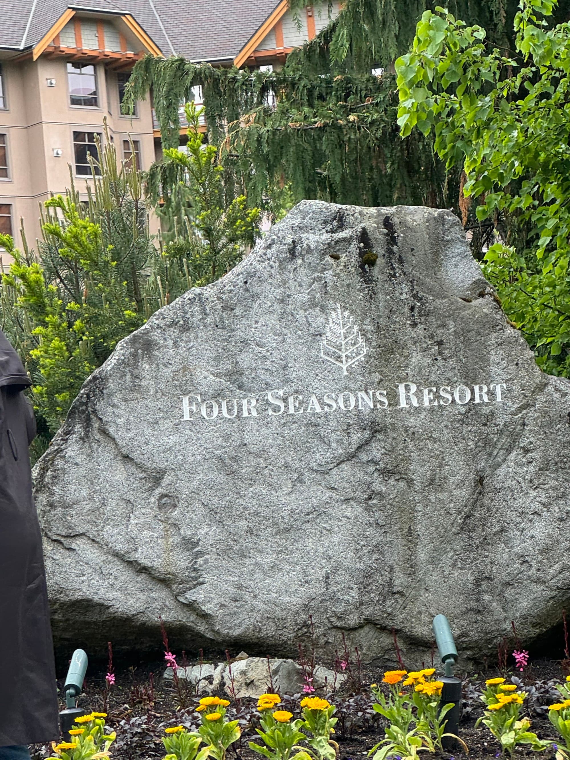 Hotel name "Four Seasons Resort" on a large boulder.