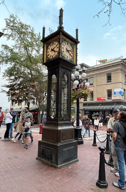 Steam clock in Gastown, an old-school, freestanding clock on a brick pavilion surrounded by people - Mindy Levin