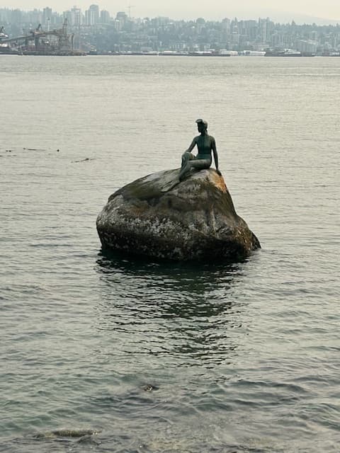 The Girl in a Wetsuit statue on a rock in Stanley Park - Mindy Levin