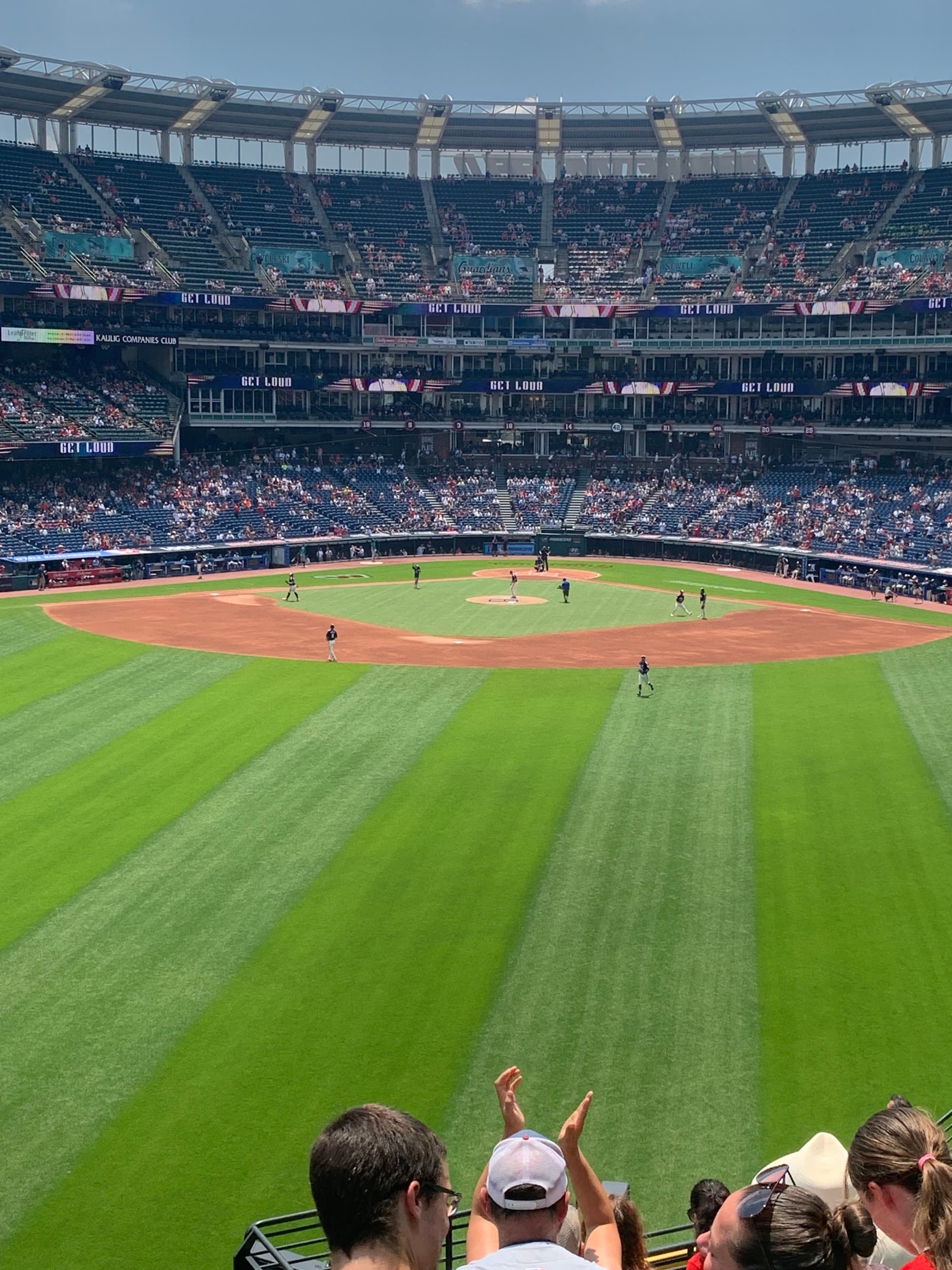 Baseball field with a diamond and crowds in the bleachers.