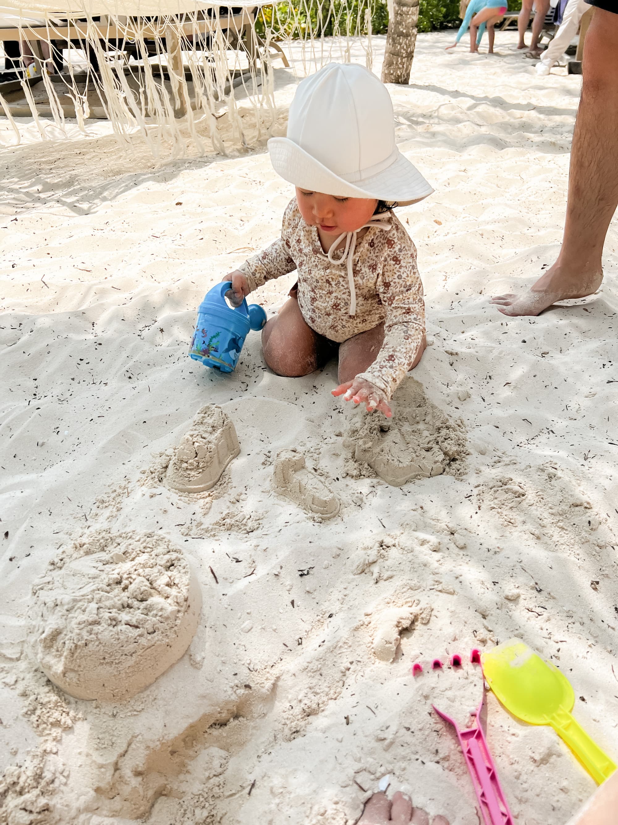 Baby girl playing on a beach.