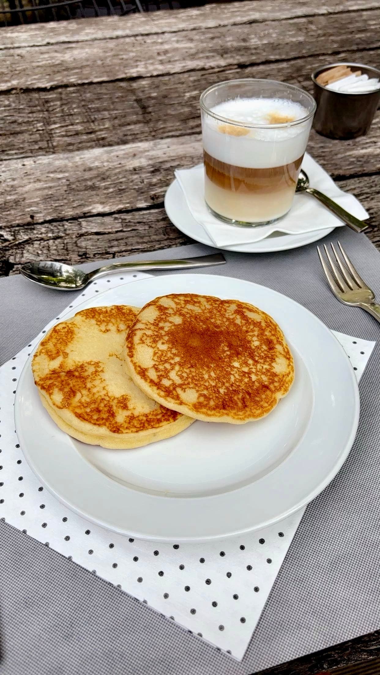 Plate with pastries and a cappuccino.