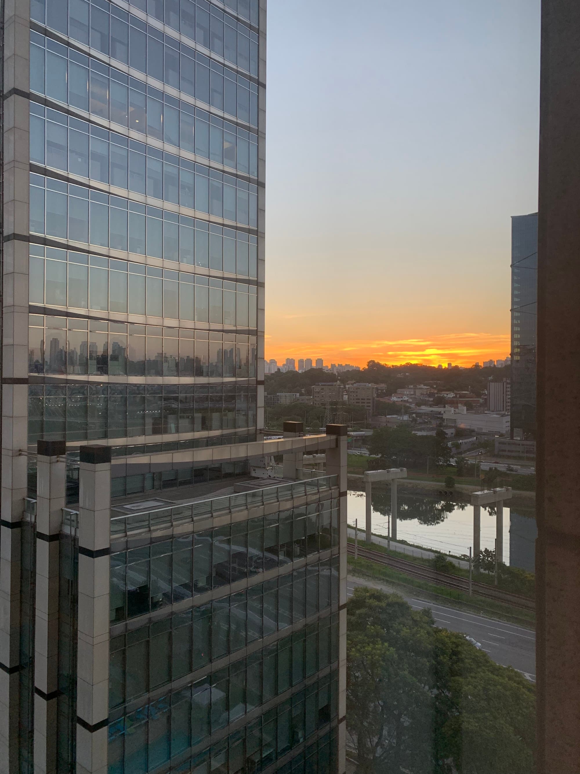Sun setting behind skyscrapers.