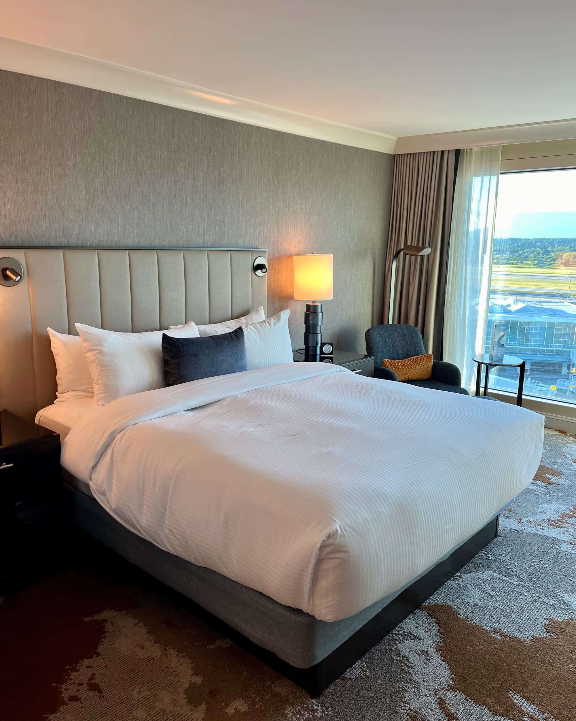 A clean hotel room with a king-sized bed.