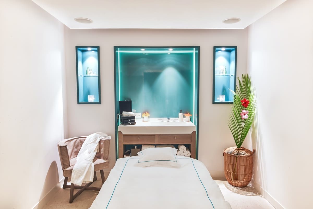 massage table in a white treatment room