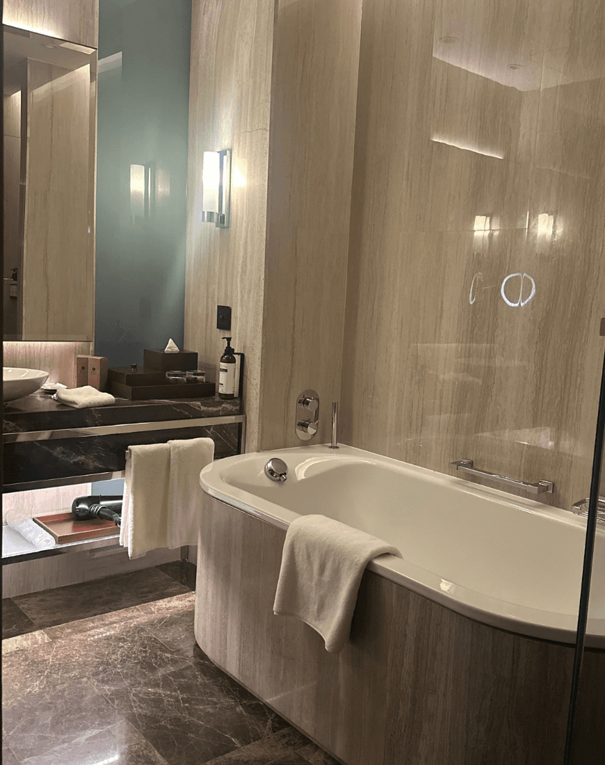 A bathtub in a hotel bathroom
