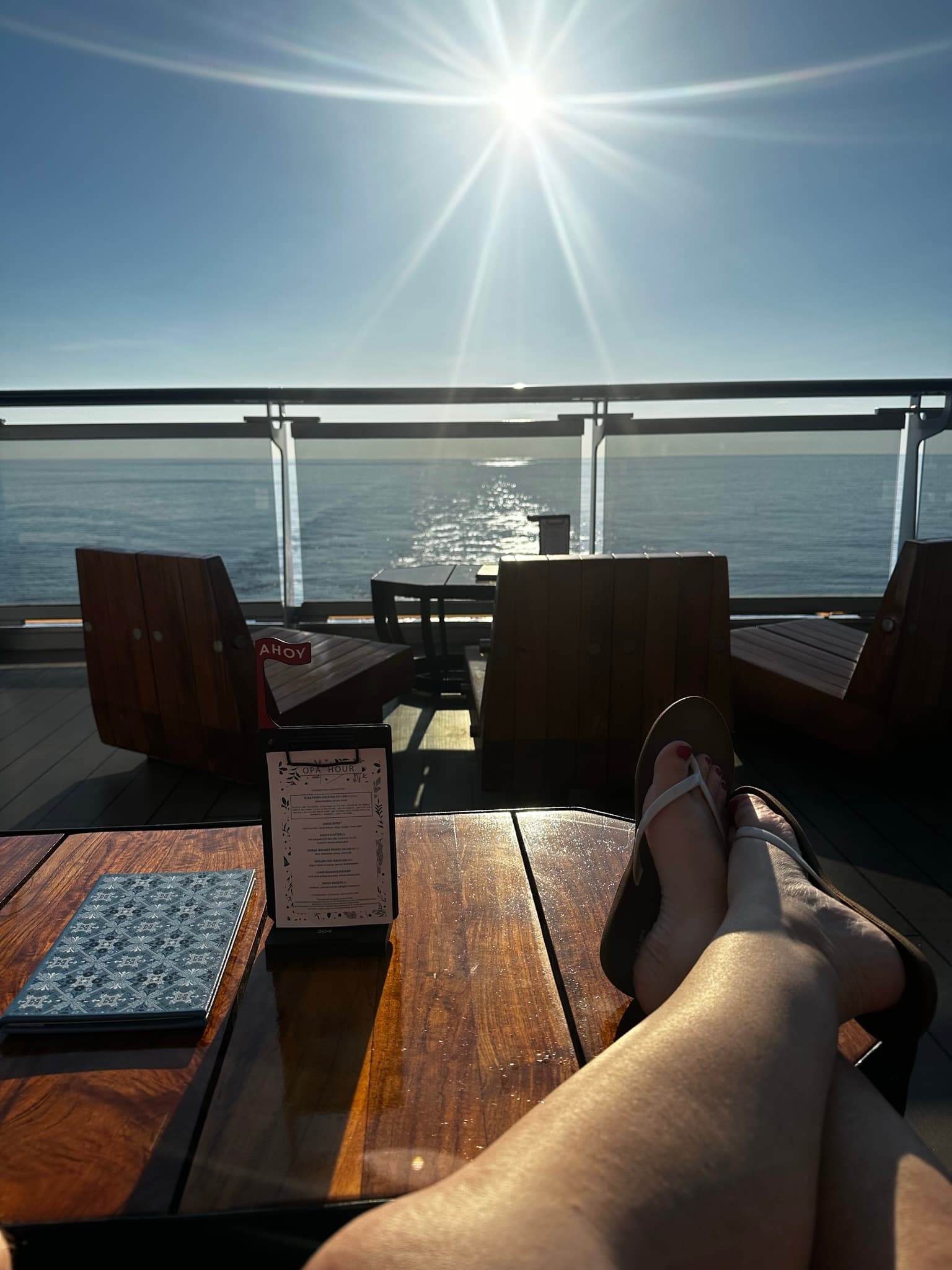 Shelly with her feet up on a table on the cruise deck