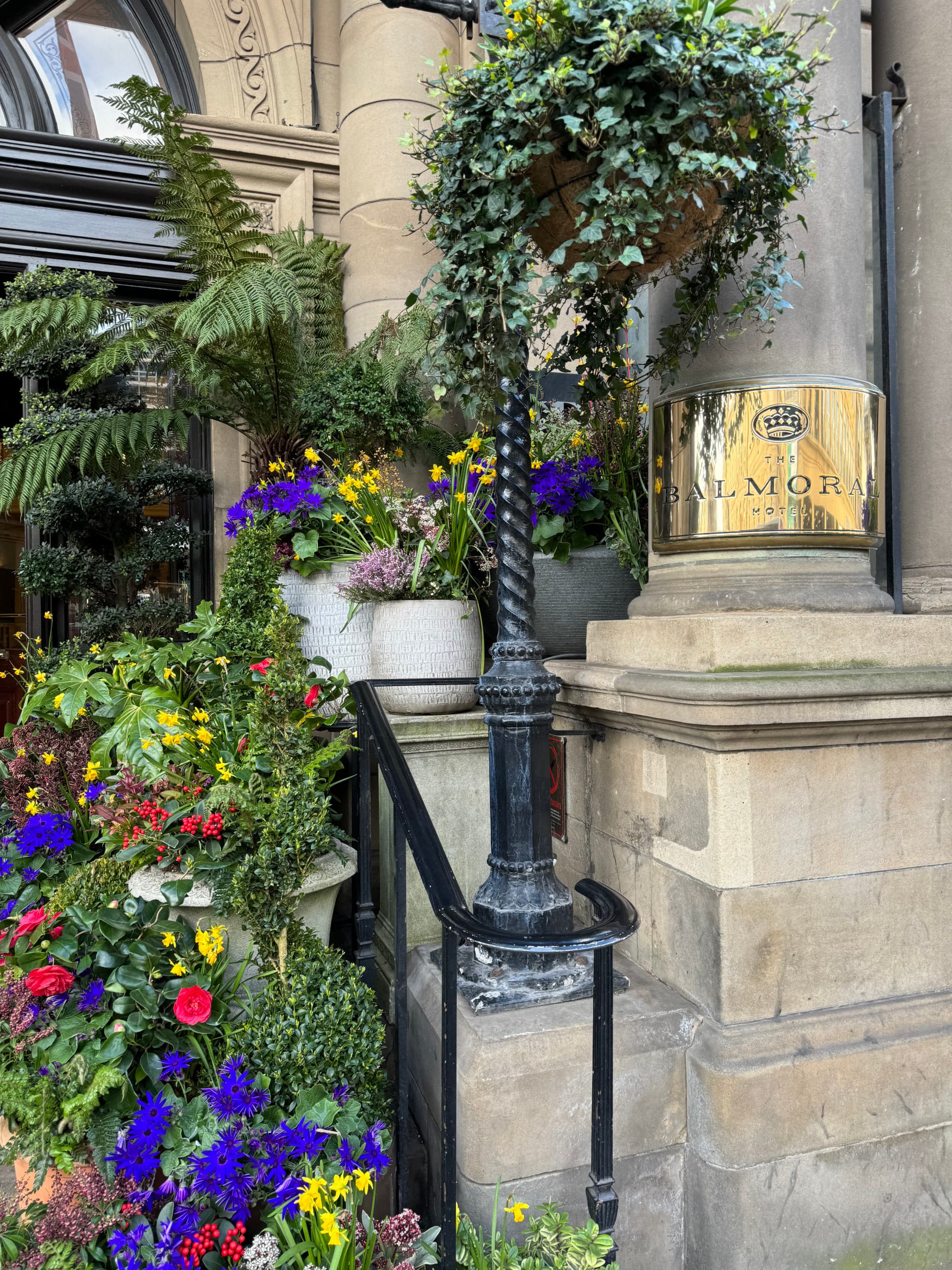 Exterior shot of the Balmoral entryway decorated with colorful flowers