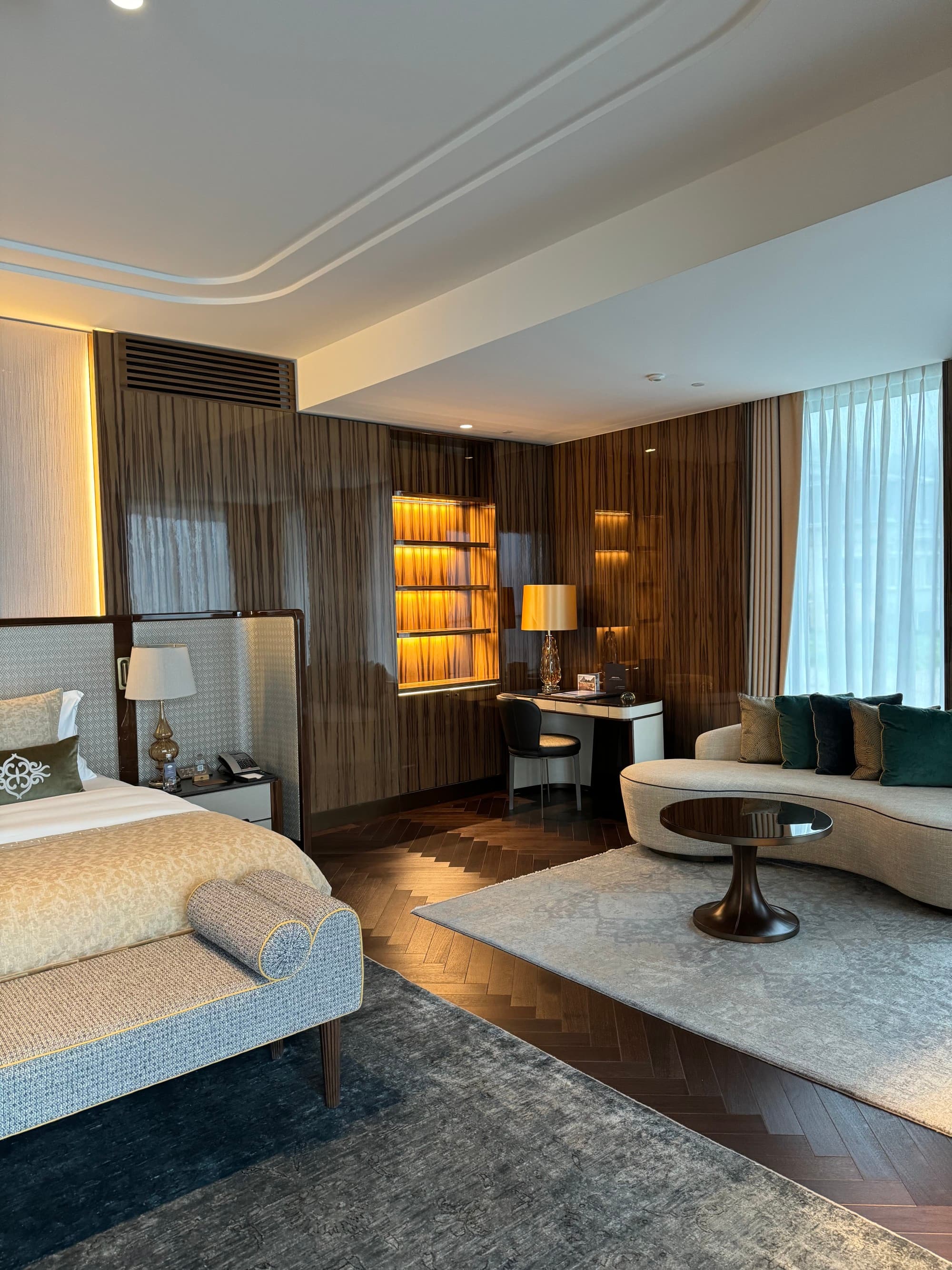 Inside another room of the hotel, with a queen-sized bed, a modern-styled couch and room decor.