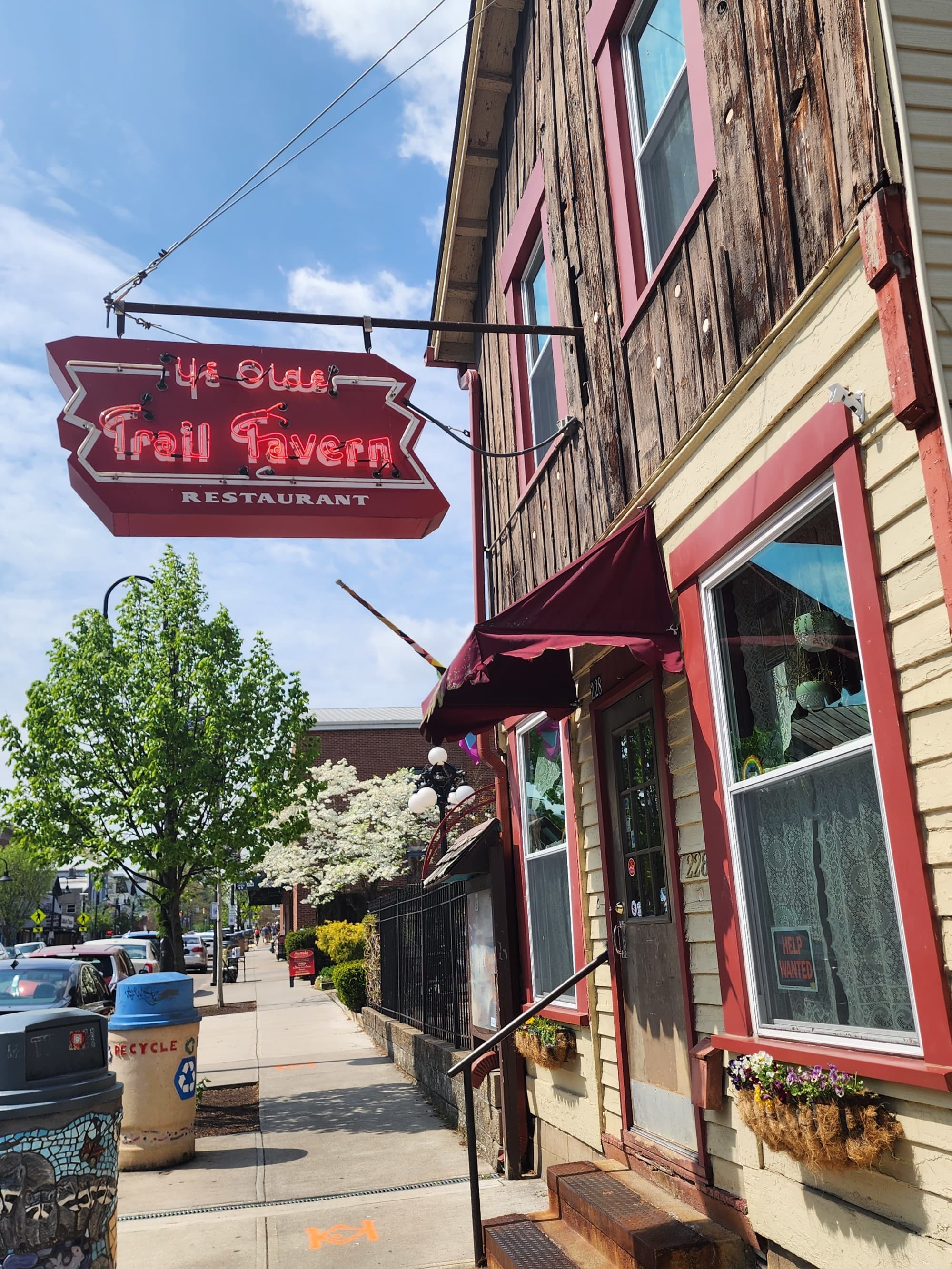 The outside of a restaurant with a red sign above