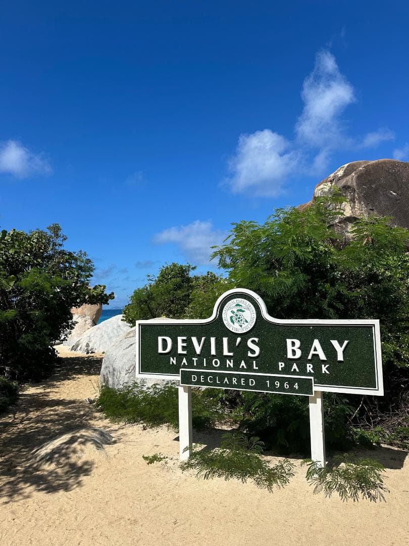 A sign on the beach reading "Devil's Bay National Park"