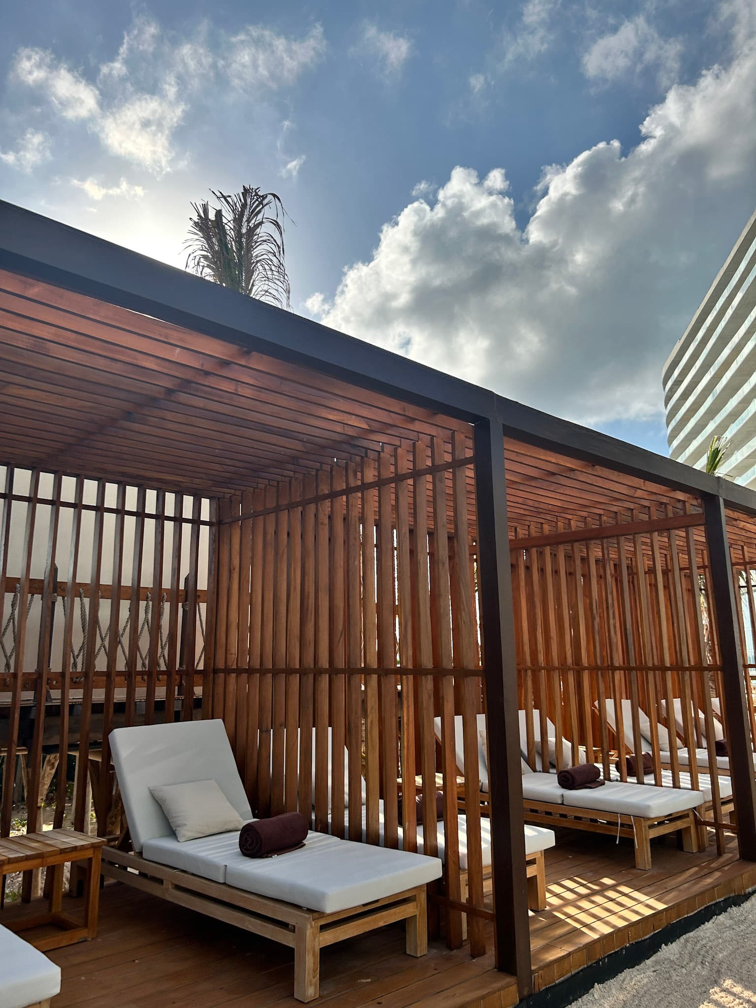 An outdoor lounge area with cabanas on a sunny day.
