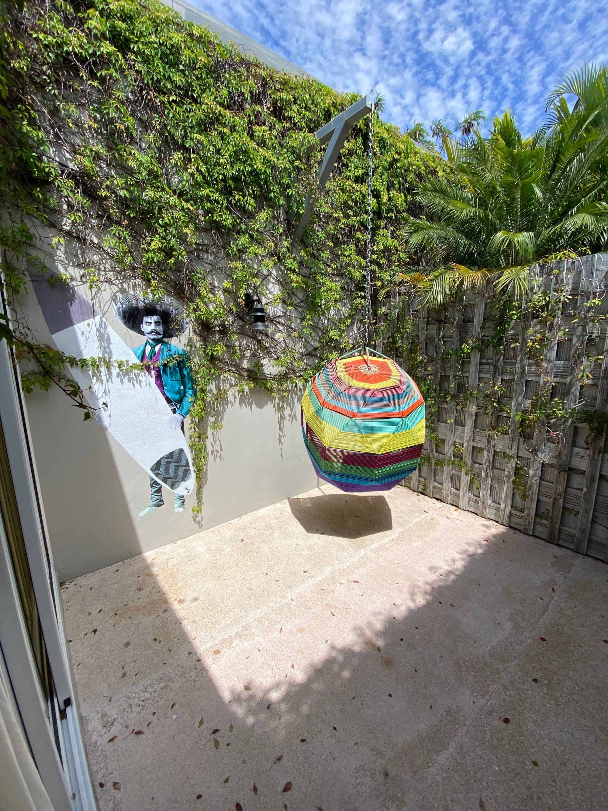 A small courtyard area with a colorful hanging chair